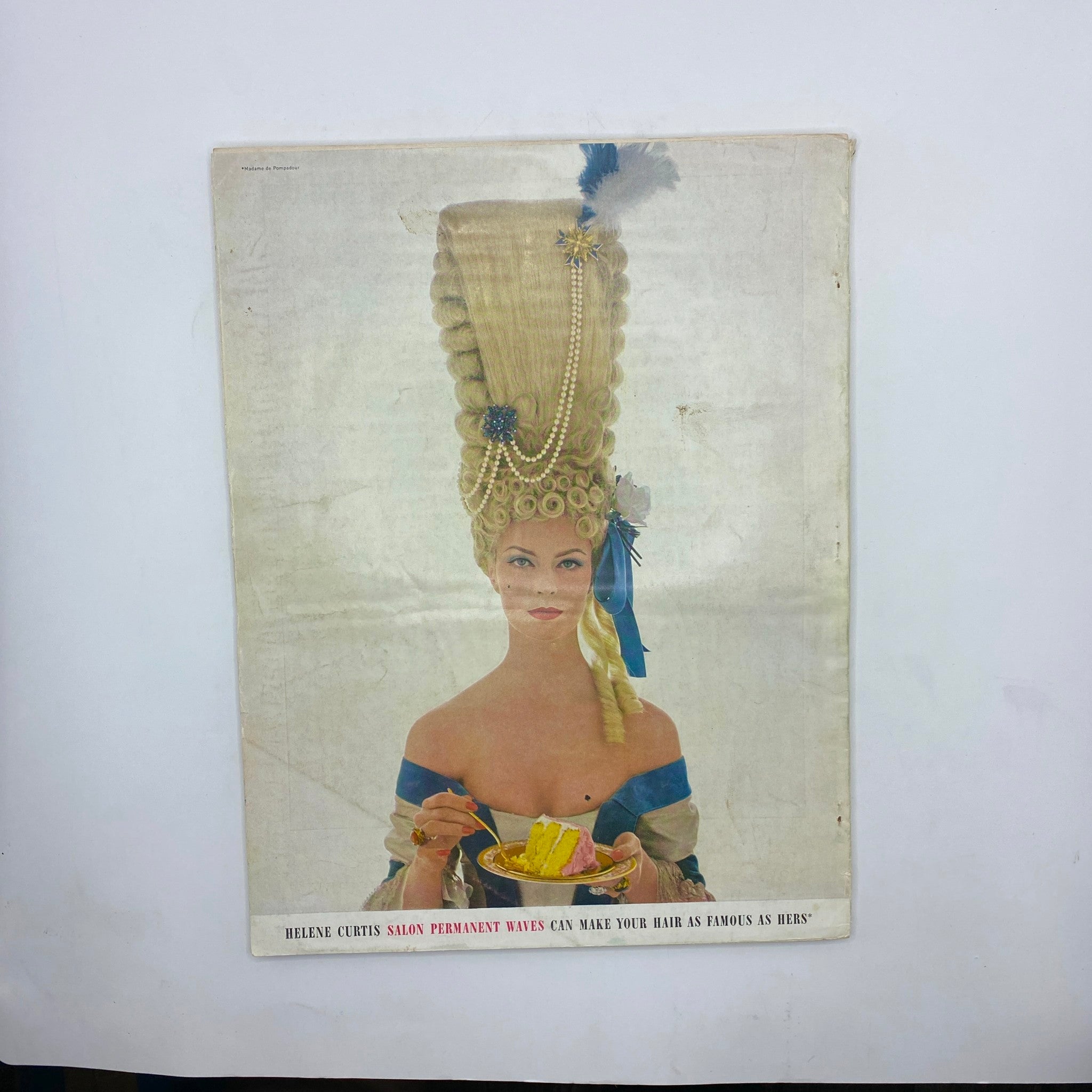 Vintage advertisement in VTG Vogue Magazine November 15 1962 depicting a model with an elaborate hairstyle while enjoying a dessert.