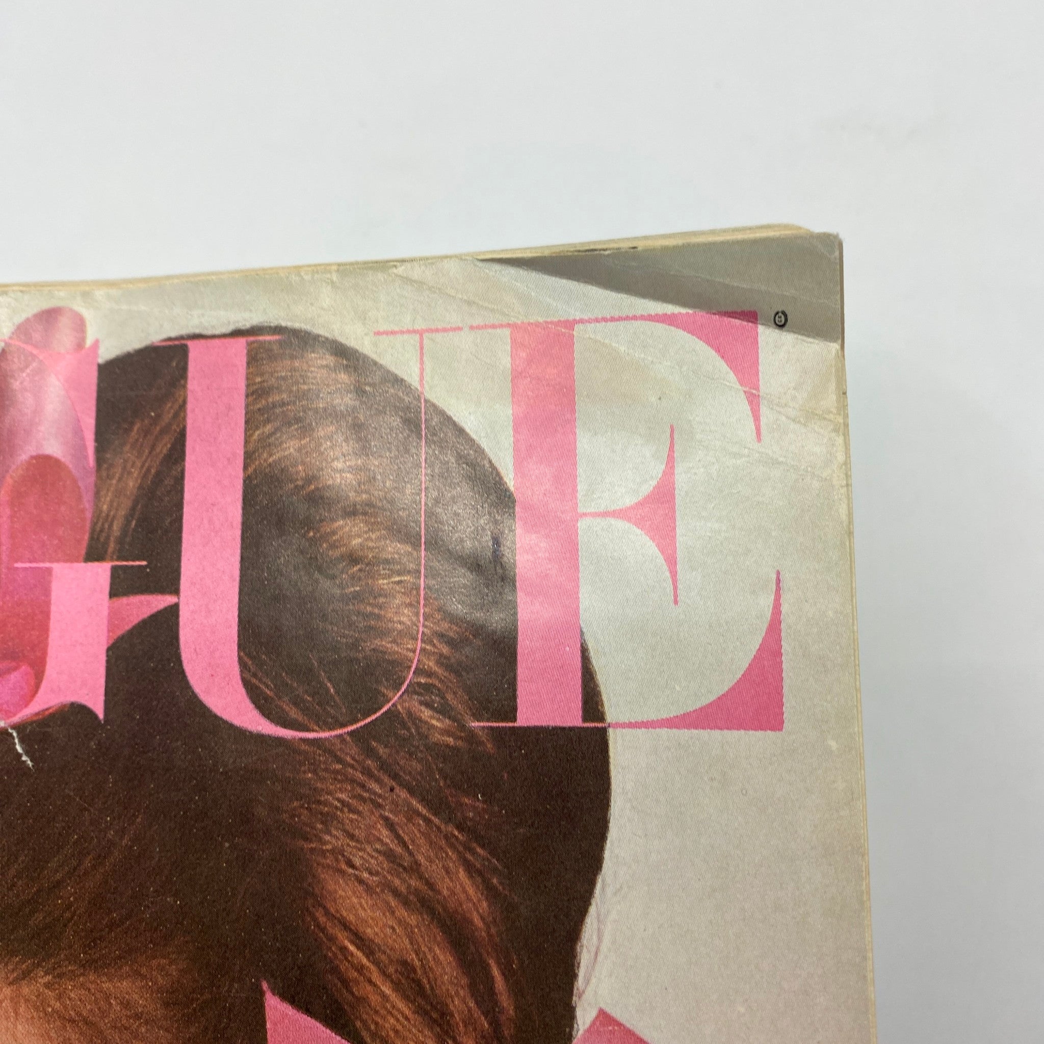 Detailed view of the top section of the vintage Vogue Magazine, November 1, 1965, featuring Brigitte Bauer, showcasing the iconic 'Vogue' title.