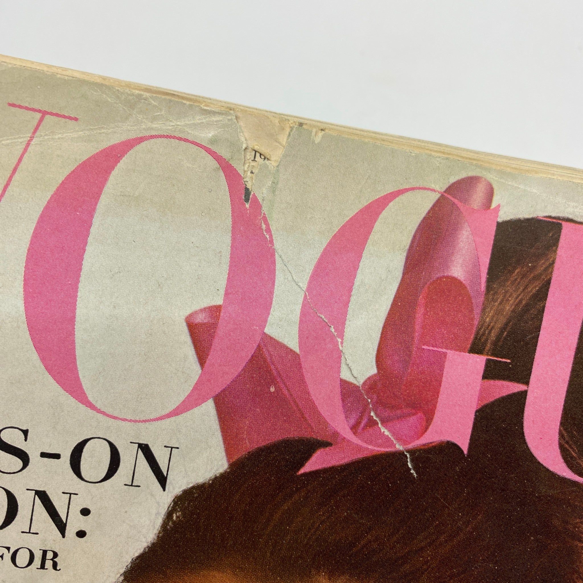 Another close-up of the vintage Vogue Magazine, November 1, 1965 featuring Brigitte Bauer, displaying wear near the title with a hint of the magazine's history.