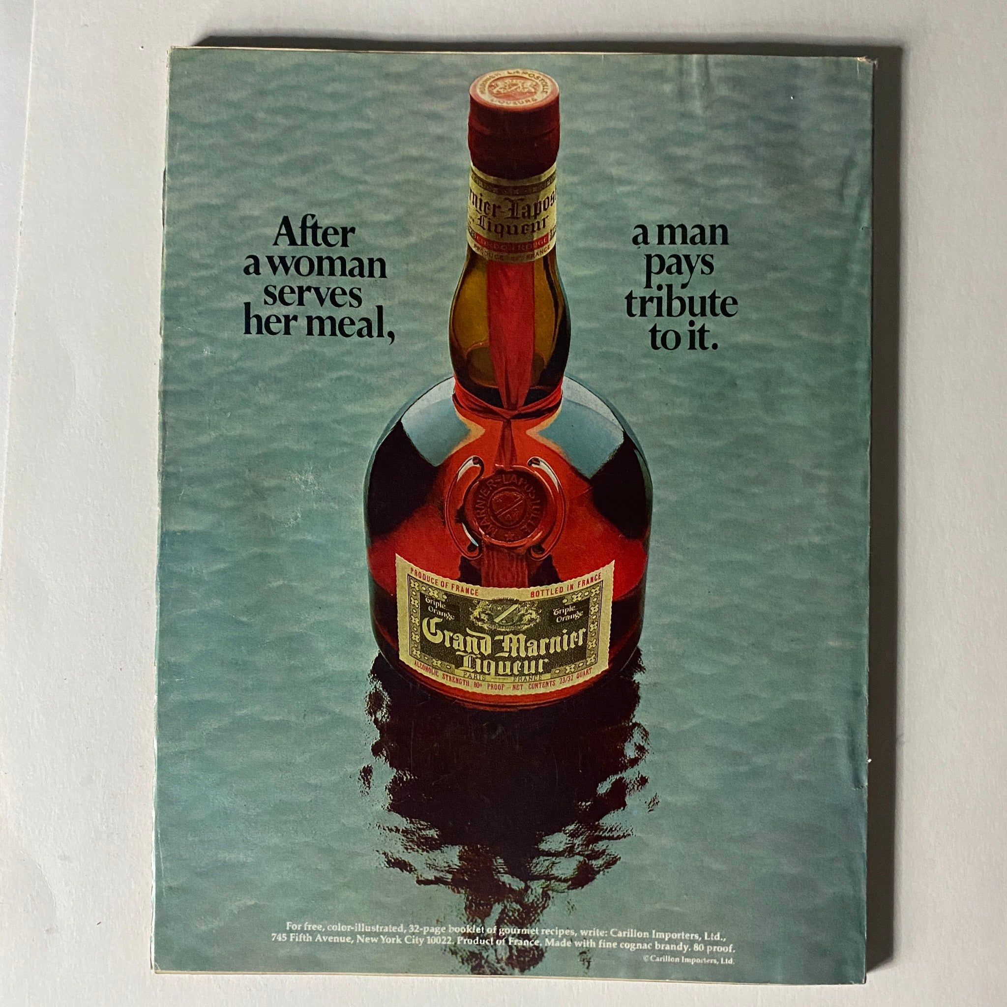 Back cover of VTG Vogue Magazine February 1 1972 featuring a Grand Marnier advertisement with a bottle prominently displayed against a turquoise background.