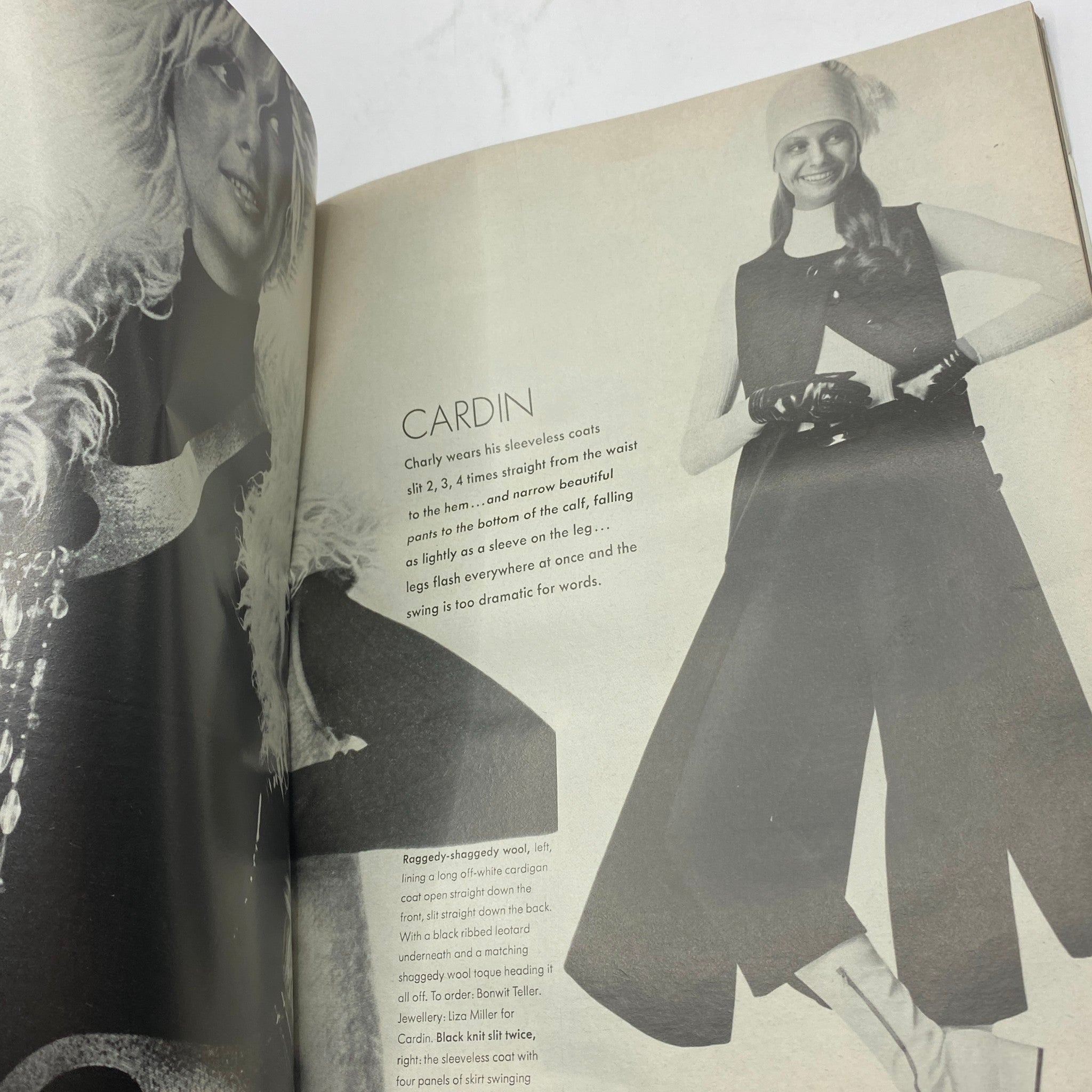 Inside page from VTG Vogue Magazine September 15, 1970 featuring fashion designs by Pierre Cardin, showcasing stylish sleeveless coats and pants, emphasizing 70s fashion aesthetics.