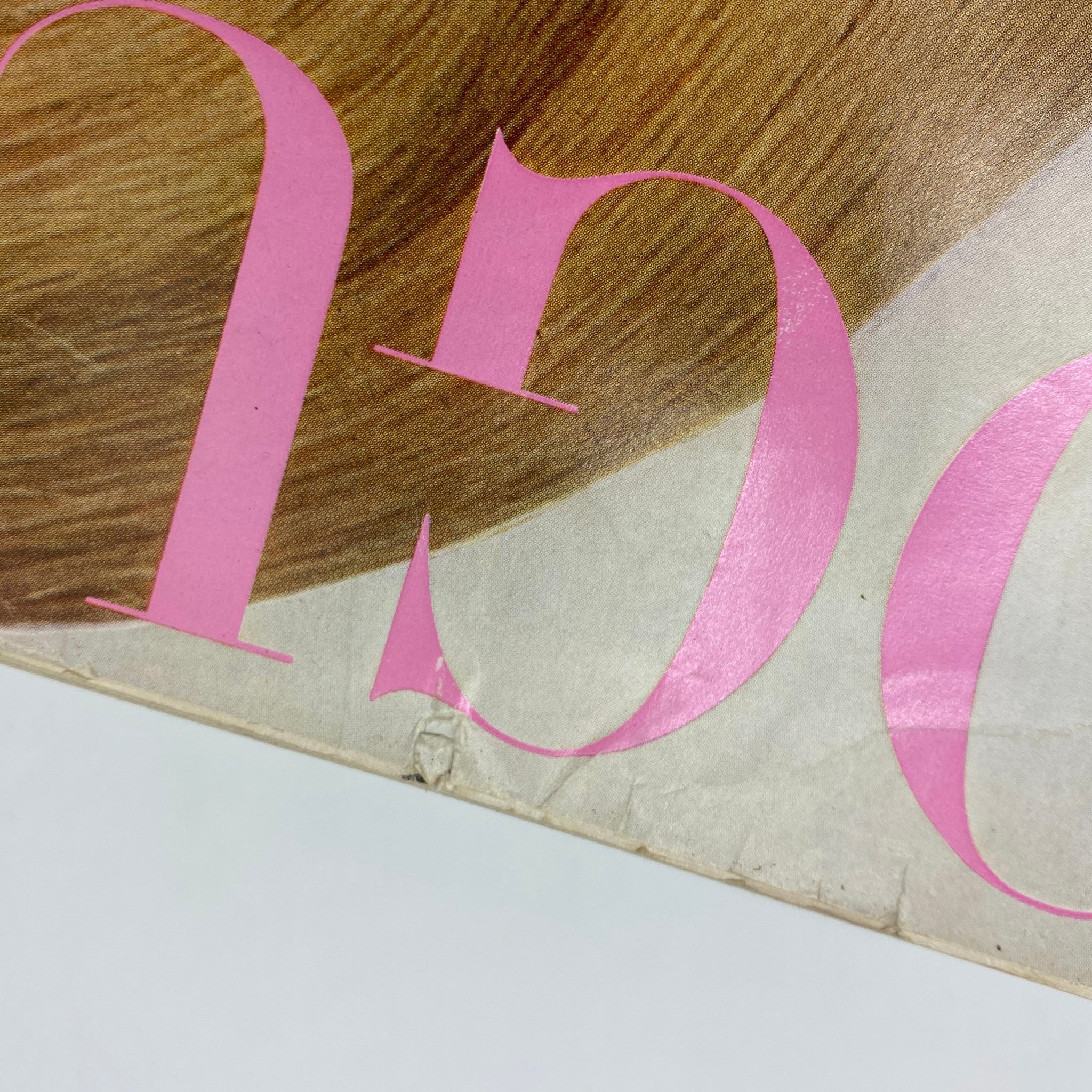 Close-up detail of the cover of VTG Vogue Magazine February 15 1966 featuring bold pink lettering - a collectible piece of fashion history.