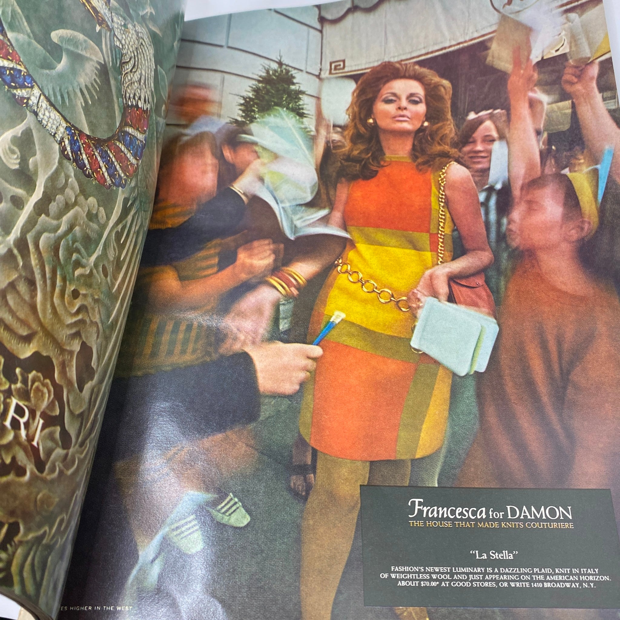 Vogue Magazine December 1967 image of a model in a colorful fashion dress surrounded by fans, depicting the iconic 1960s fashion vibe.