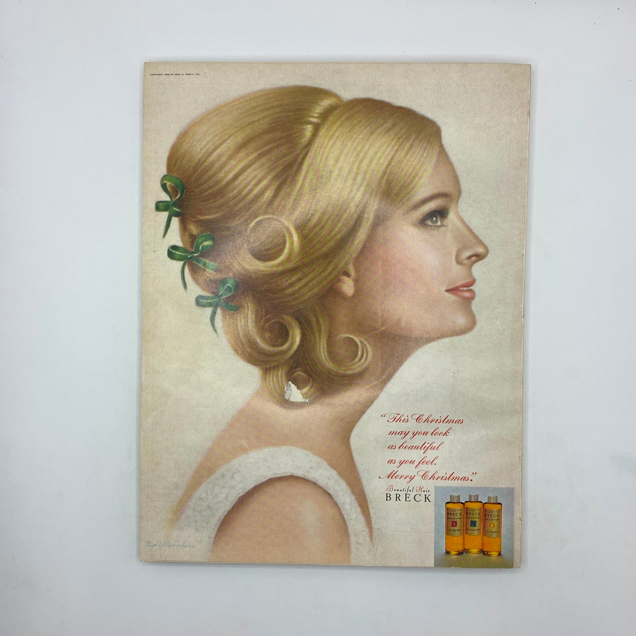 VTG Vogue Magazine December 1967 featuring a vintage Christmas advertisement with a blonde woman styled elegantly, promoting Breck hair products.