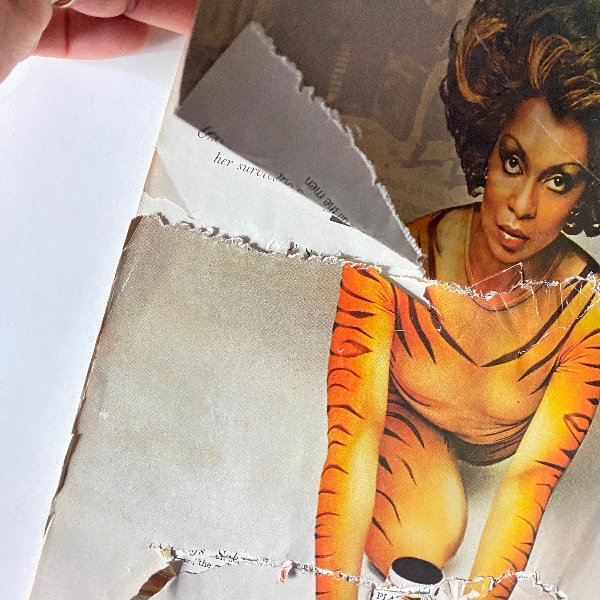 Close-up view of the vintage advertisement from the December 1975 VTG Vogue Magazine featuring a model in a tiger-themed outfit promoting Tigress perfume.