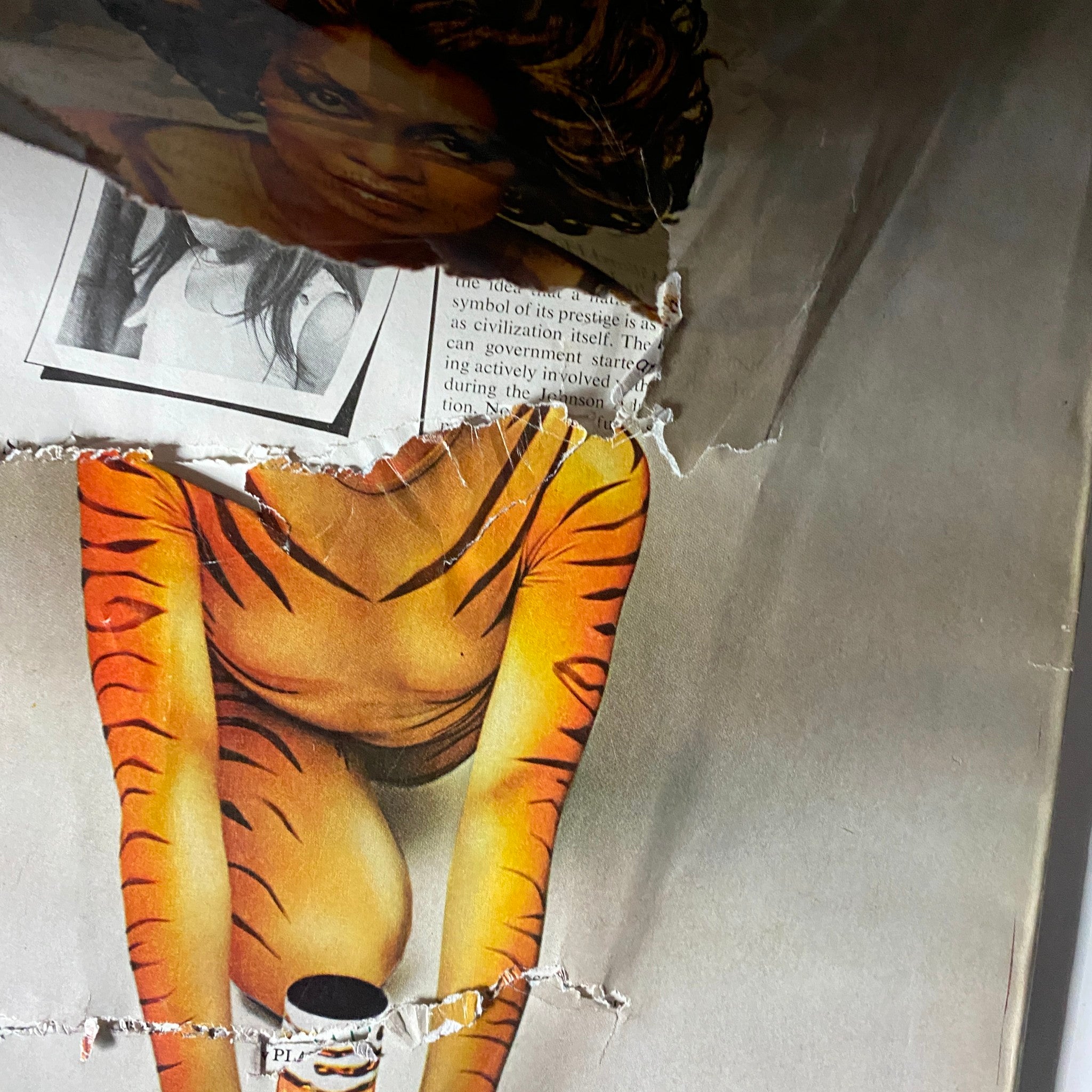 Another close-up of the damaged vintage advertisement from the December 1975 VTG Vogue Magazine focusing on the model in a striking tiger-themed outfit for Tigress perfume.