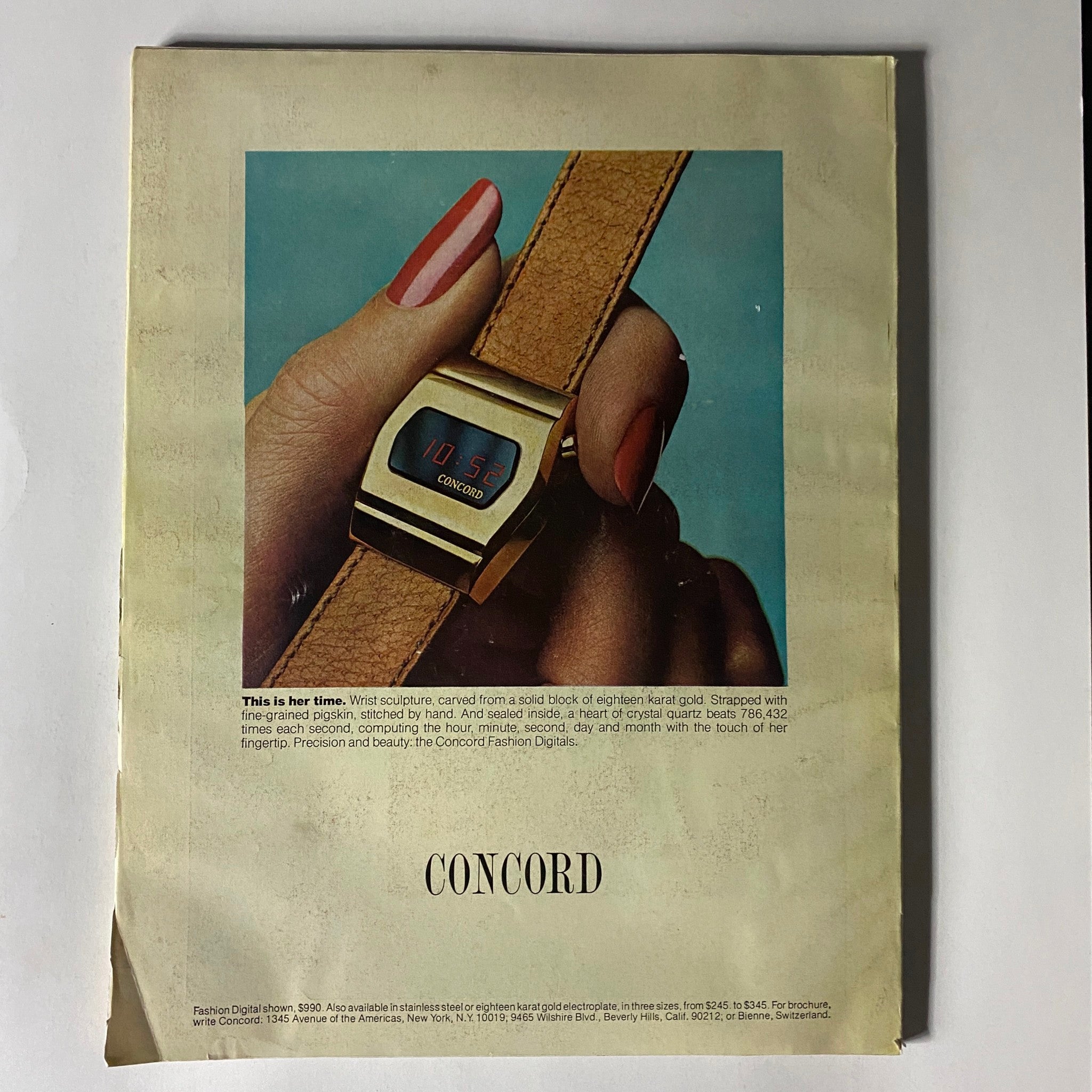 Concord wristwatch advertisement with a hand modeling the elegant watch in VTG Vogue Magazine August 1976.