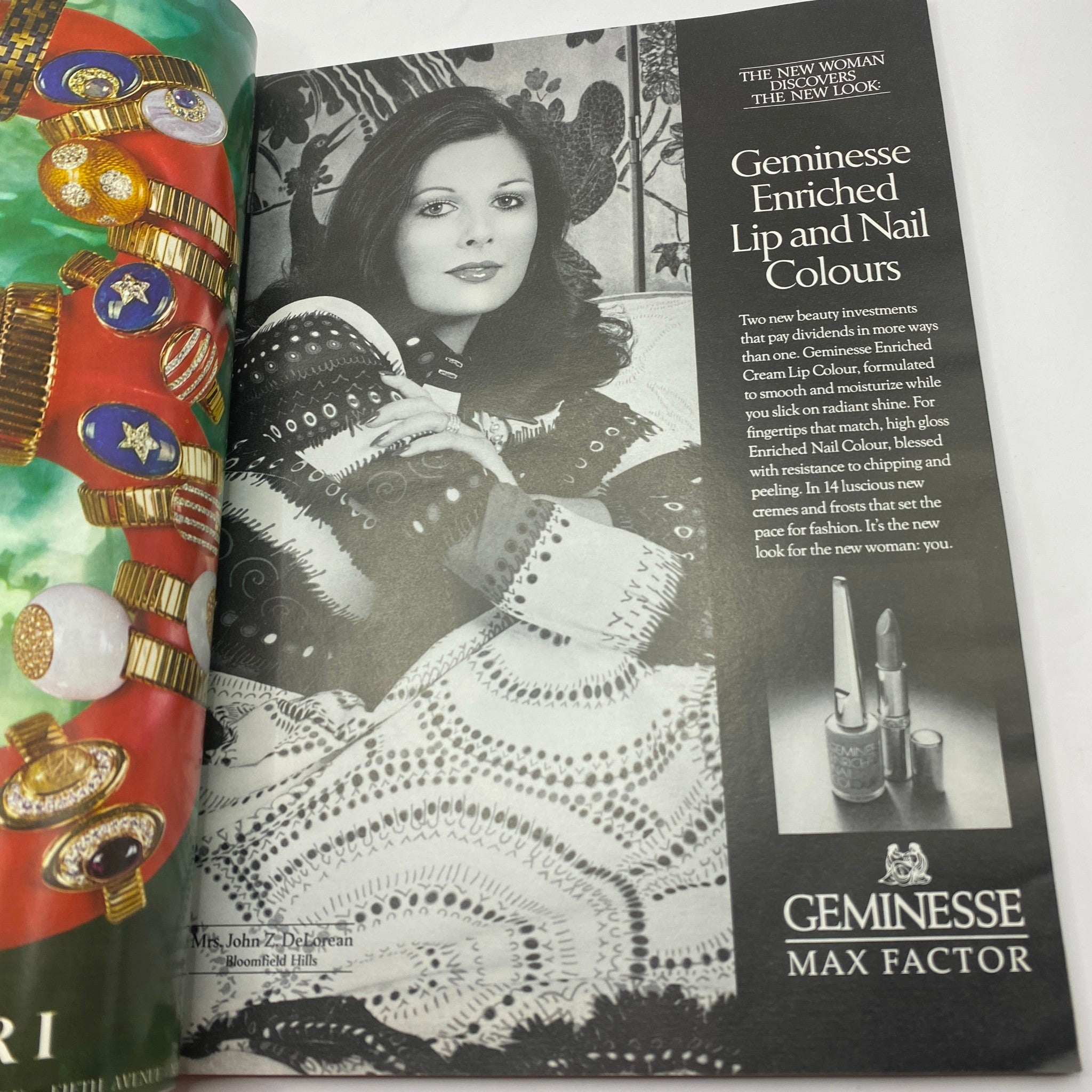 Ad for Geminesse Enriched Lip and Nail Colours in VTG Vogue Magazine November 1973, featuring a model with styled hair wearing a patterned shawl and surrounded by colorful jewelry, emphasizing beauty products.