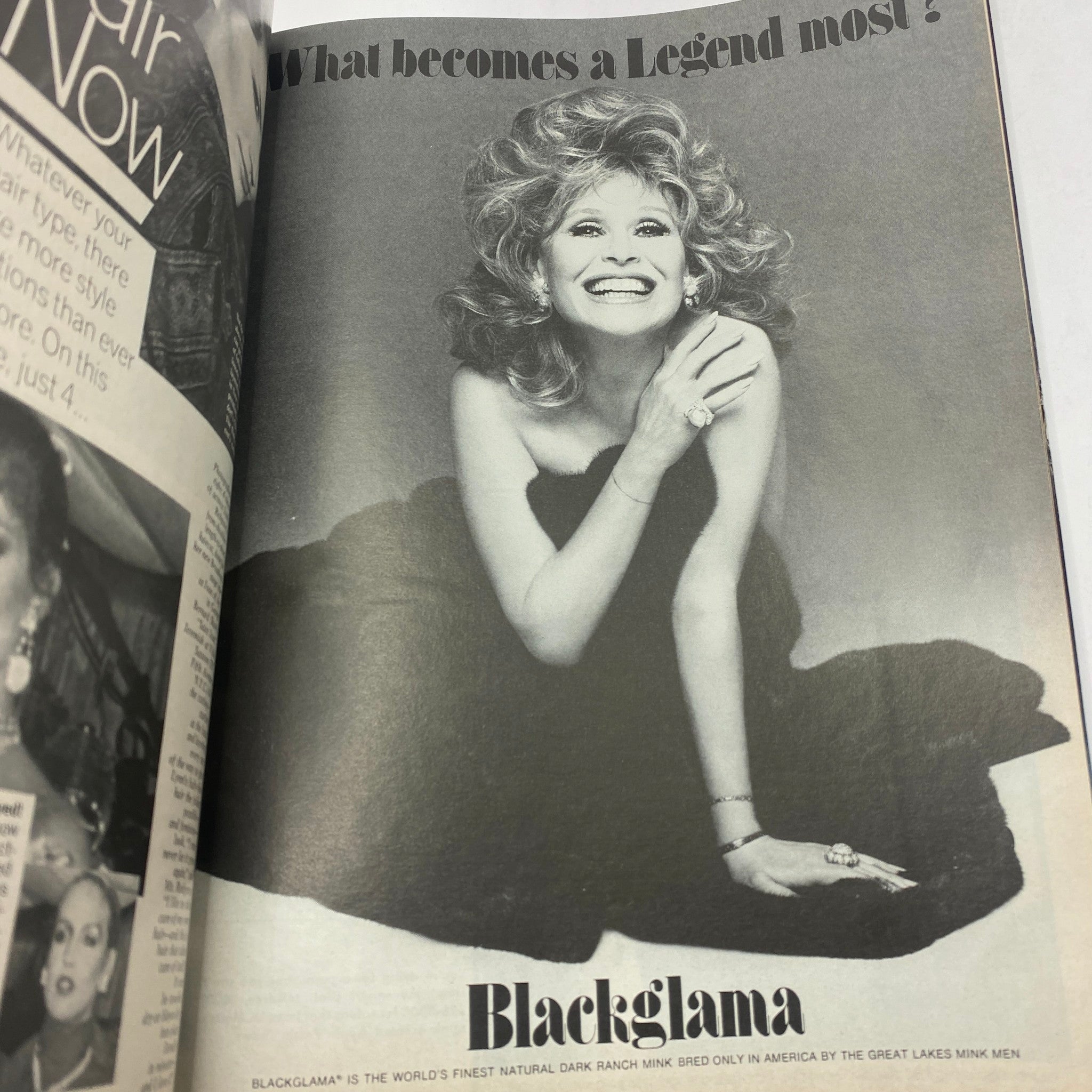 Vintage Vogue Magazine December 1977 featuring an iconic black and white advertisement of a cheerful woman in a glamorous setting, promoting Blackglama fur, reflecting the fashion trends of the late '70s.