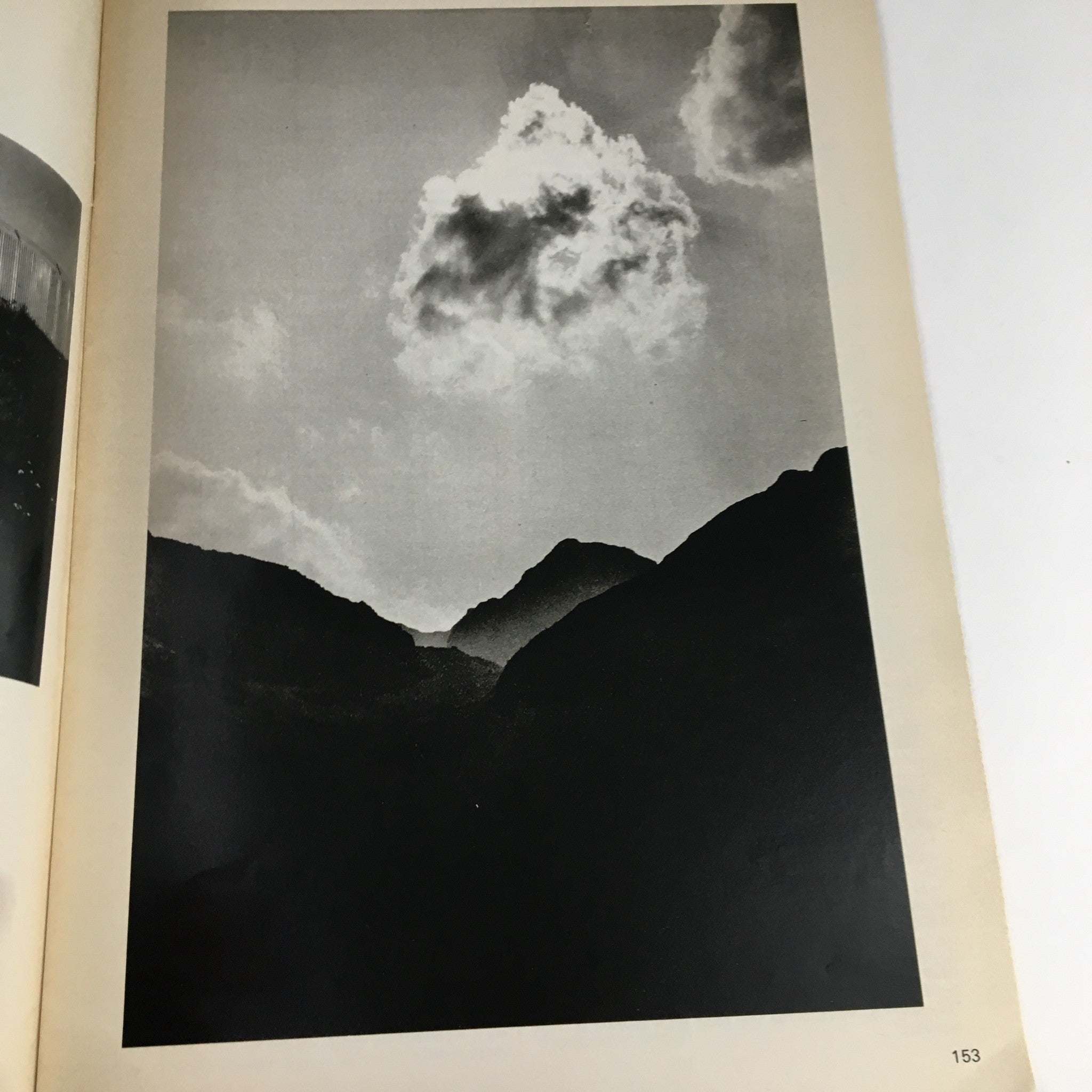 Artistic black and white photograph found in Creative Camera Magazine May 1976, depicting dramatic mountain silhouettes and clouds, representing the photography style of the 1970s.