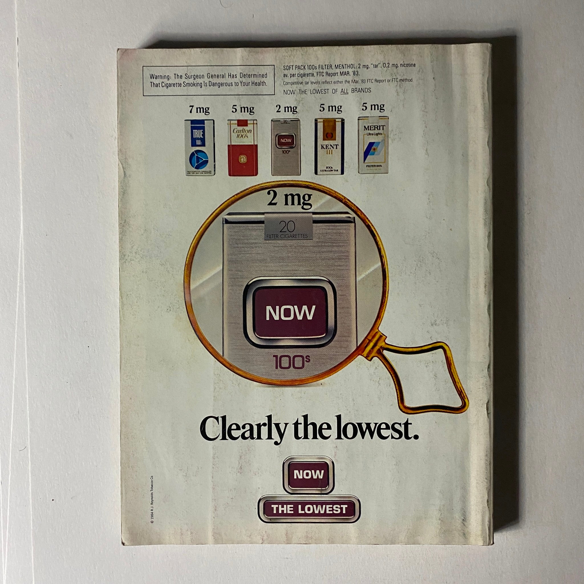 Back cover of Vintage Vogue Magazine April 1984 displaying an advertisement for NOW cigarettes, illustrating traditional advertising from the 1980s, a piece of vintage memorabilia.