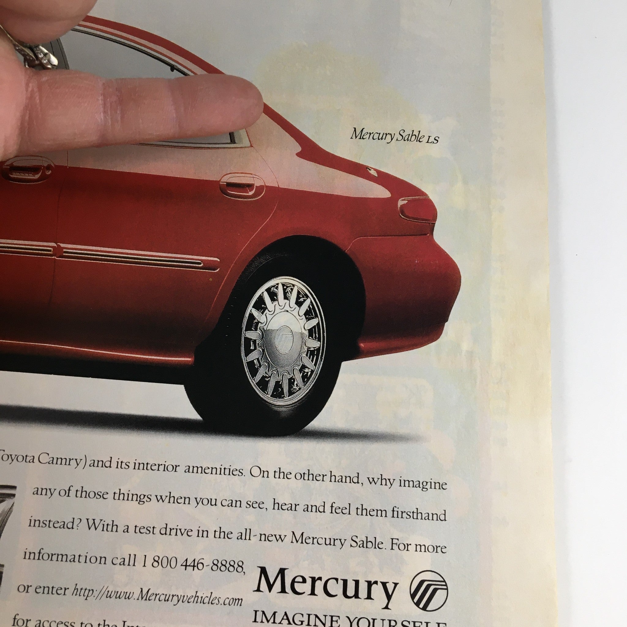 Advertisement for Mercury Sable LS from the October 23, 1995 Newsweek Magazine, showcasing the car and its features.