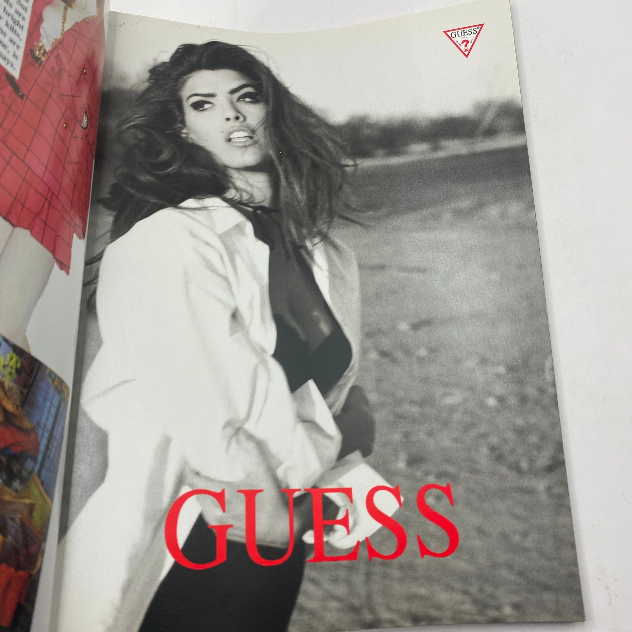 Inside page of Vogue Magazine July 1991 featuring a Guess advertisement with a model in a white shirt. Collect this vintage magazine showcasing early '90s fashion trends.