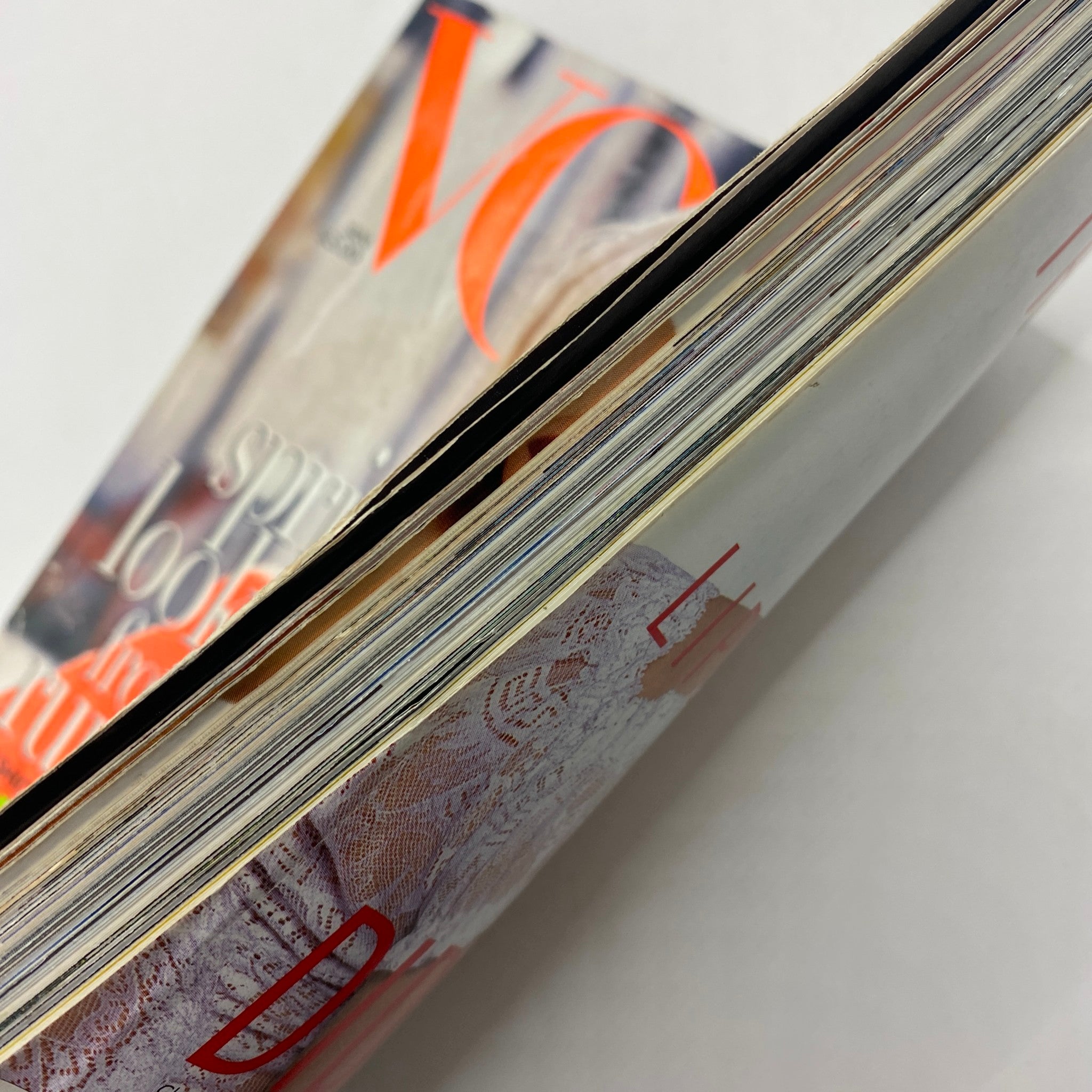 Close-up view of the spine and edges of Vogue Magazine January 1996, illustrating the well-preserved condition of the vintage publication.