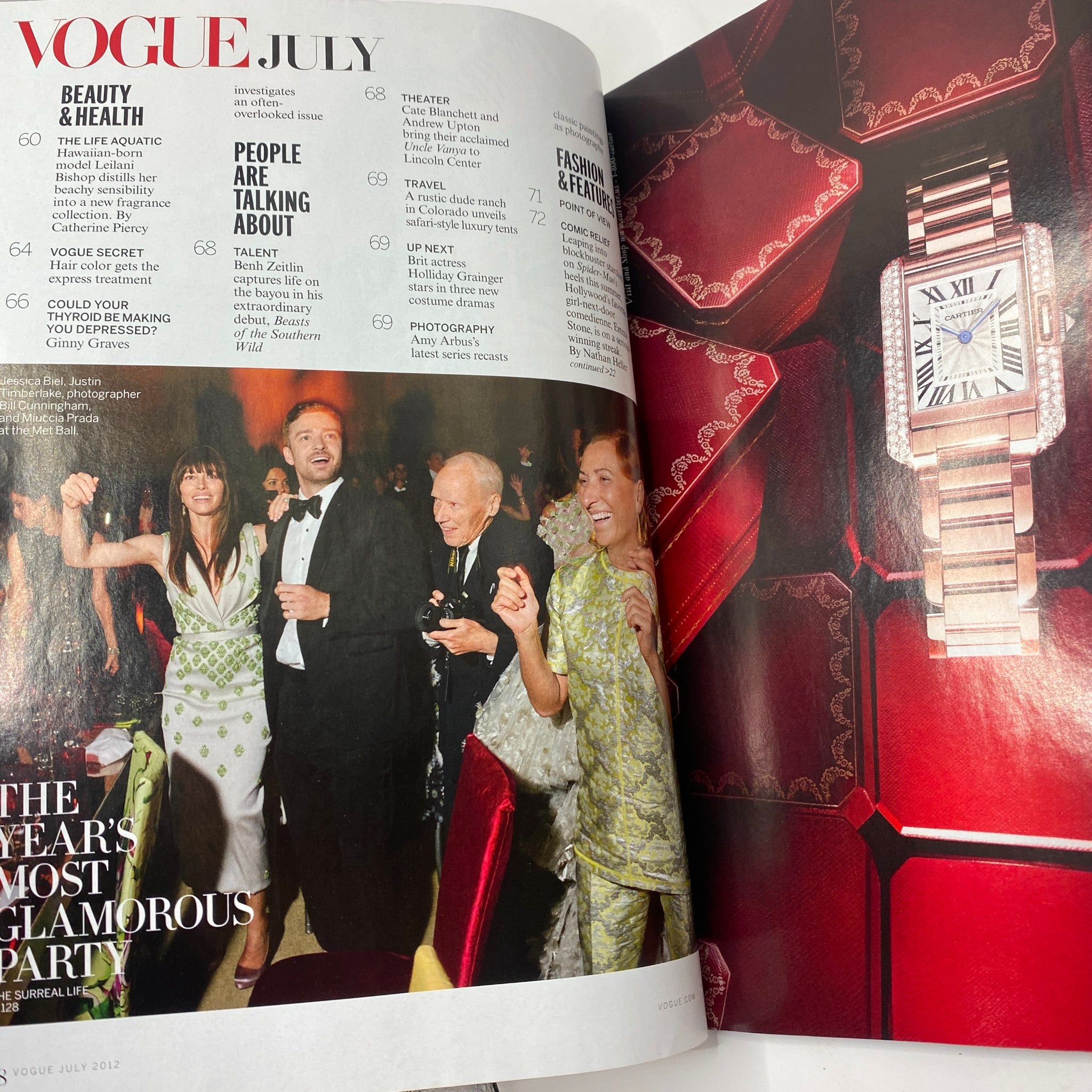 Inside spread of Vogue Magazine July 2012 featuring a glamorous event scene with notable characters and a fashion article.