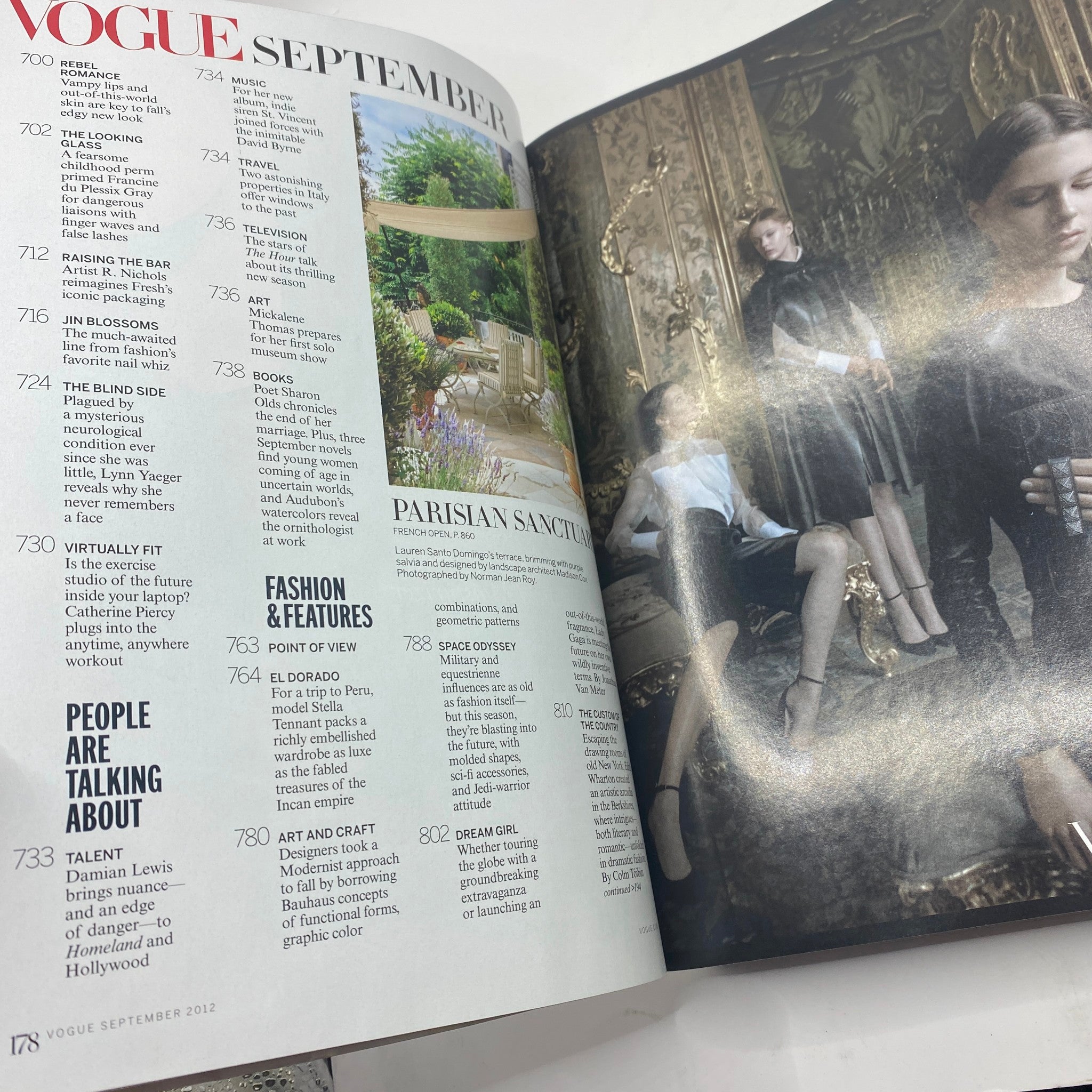Inside spread of Vogue Magazine September 2012 featuring editorial content, highlighting fashion articles and reviews along with photographs, including a floral garden scene and models, emphasizing contemporary fashion trends.