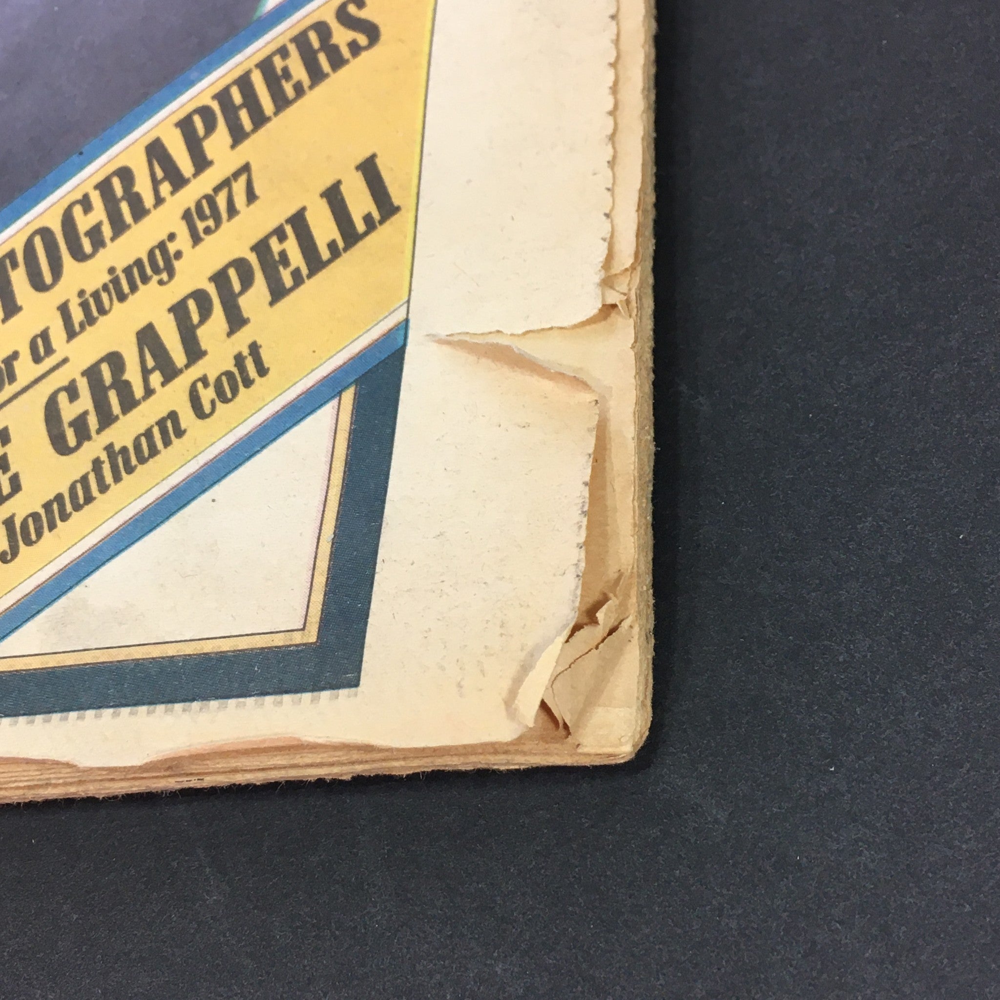 Close-up of the cover corner of the VTG Rolling Stone Magazine from May 19, 1977, featuring details of the magazine's design and condition, highlighting imperfections along the edge which adds to its vintage character.