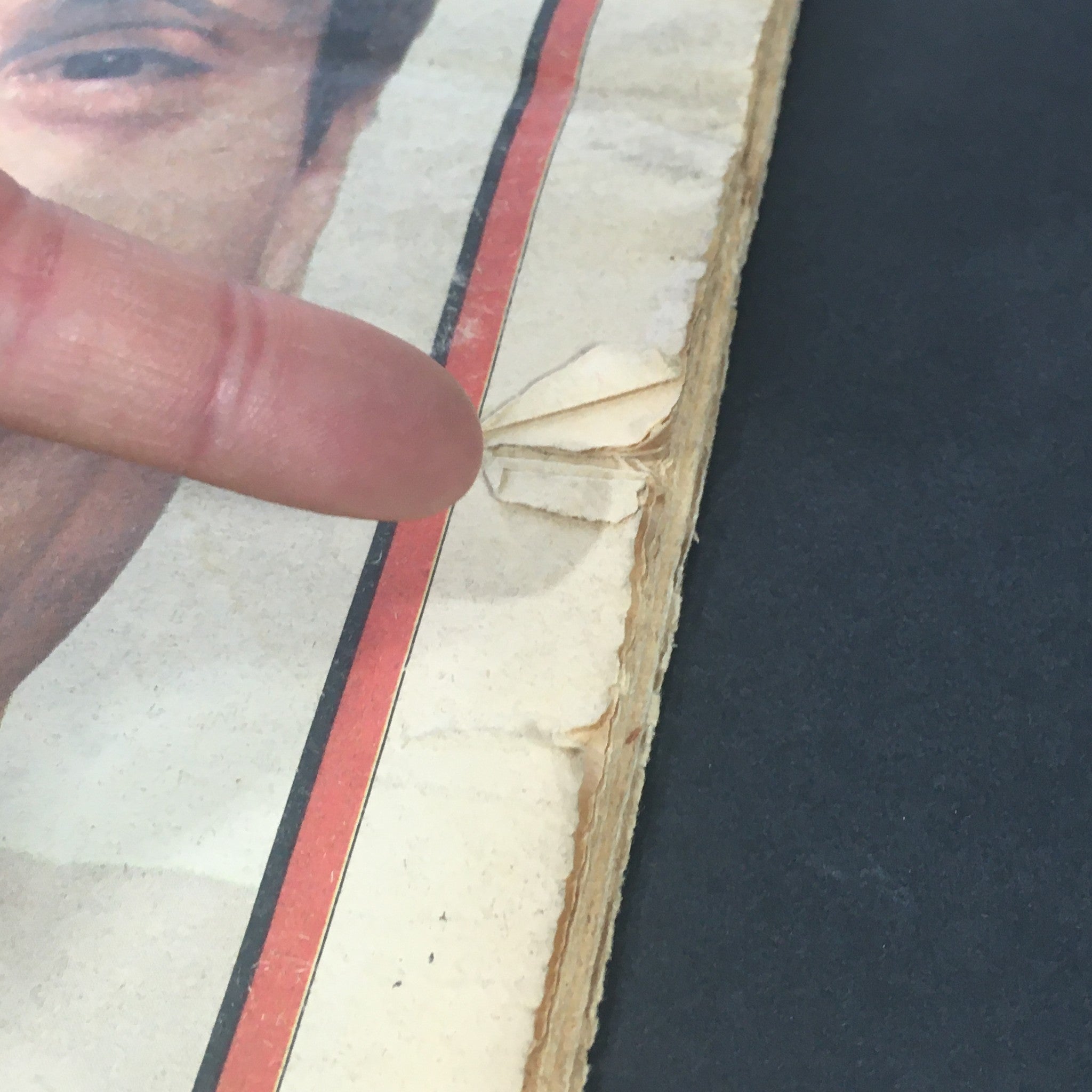 Detailed view of the spine of VTG Rolling Stone Magazine June 16 1977, emphasizing wear and tear and the condition of the publication.