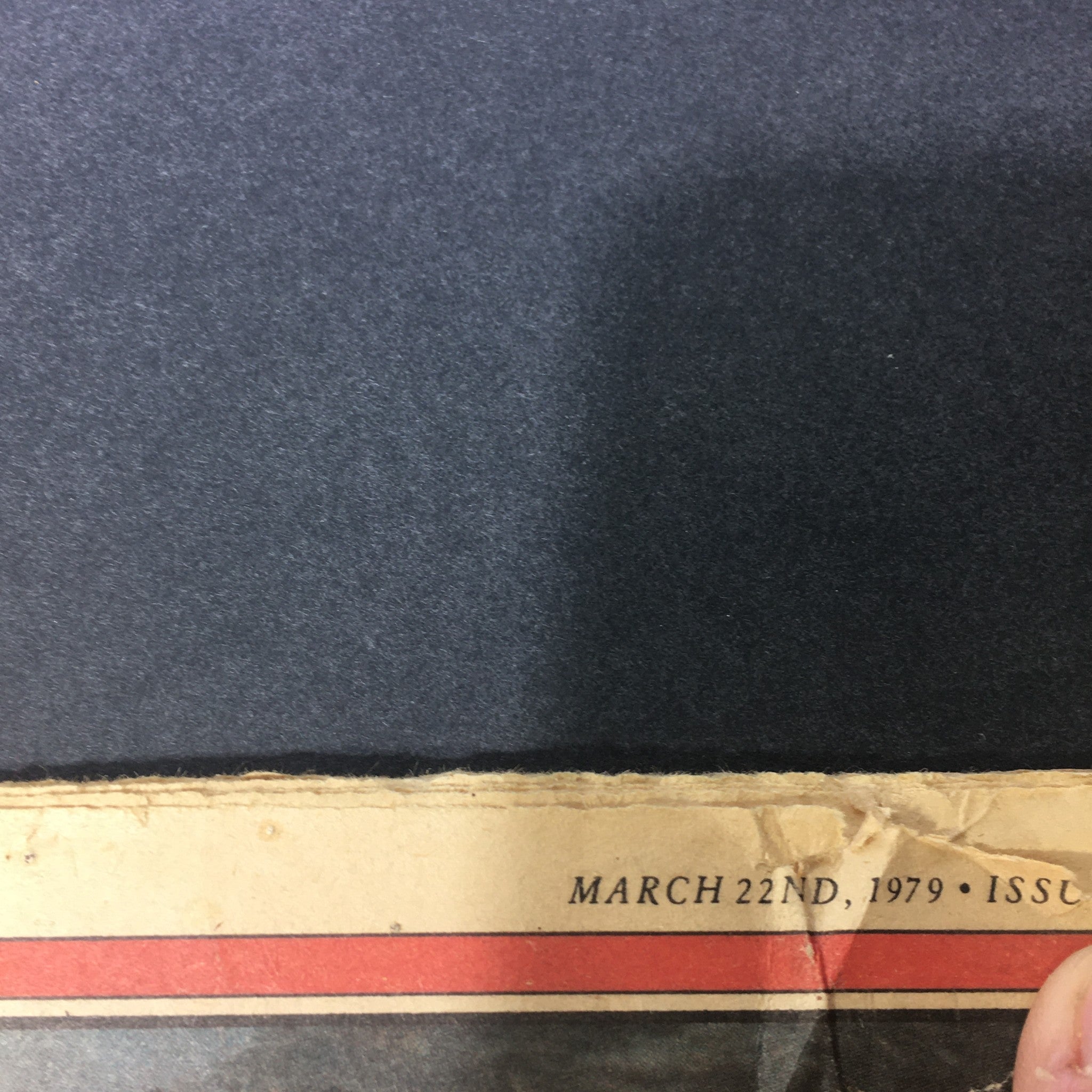 Close-up view of the bottom edge of the VTG Rolling Stone Magazine March 22 1979, highlighting the date and signs of aging, reflecting its vintage charm.