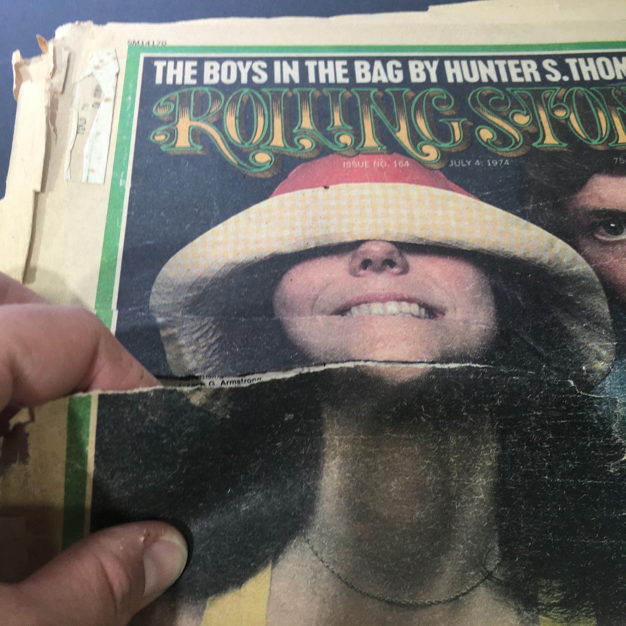 Close-up view of the Vintage Rolling Stone magazine from July 4, 1974, with Jane Fonda's smiling face partially obscured, highlighting the magazine's age and wear.