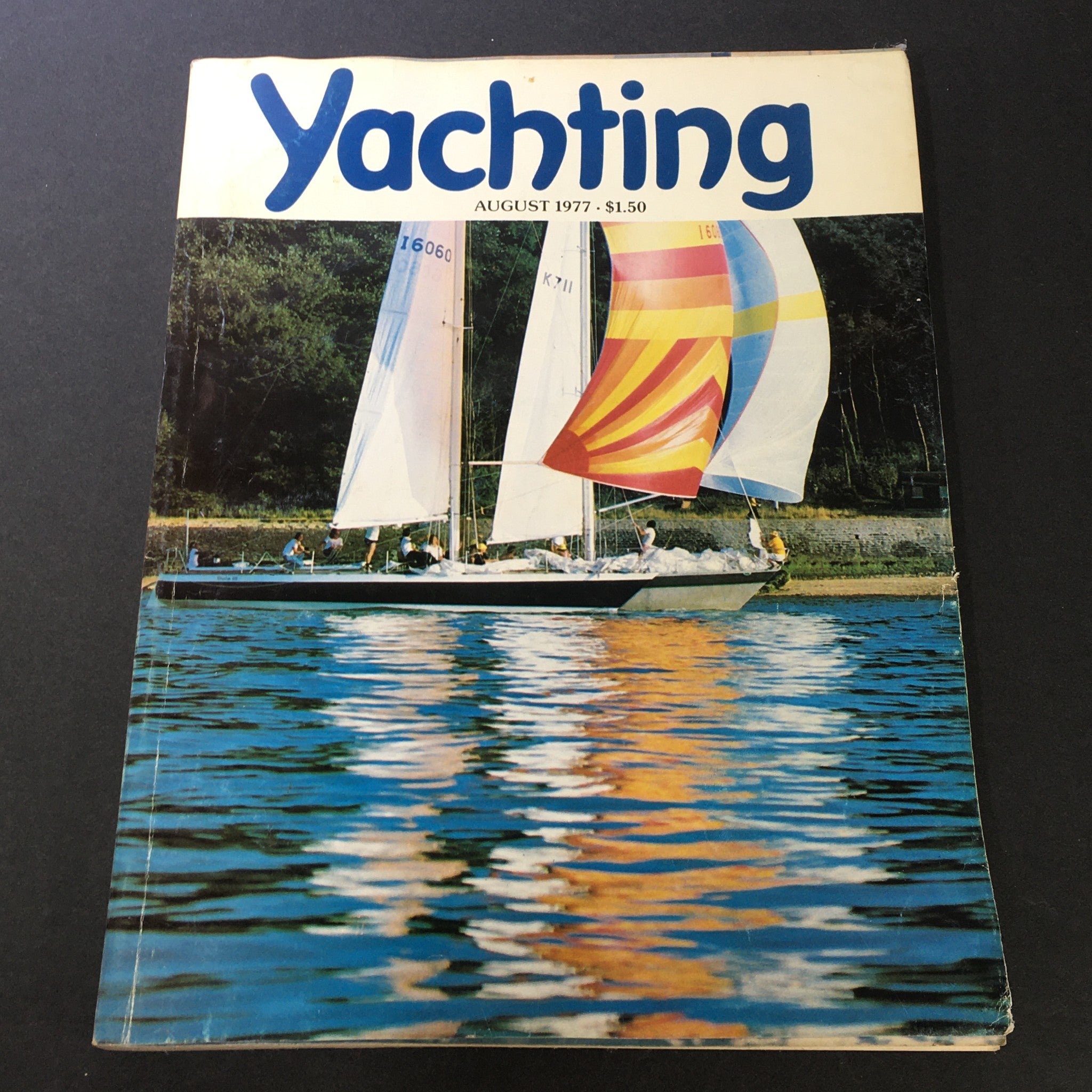 Cover of VTG Yachting Magazine August 1977 showcasing sailboats on calm waters with vibrant sails, reflecting the spirit of offshore racing and sailing culture.