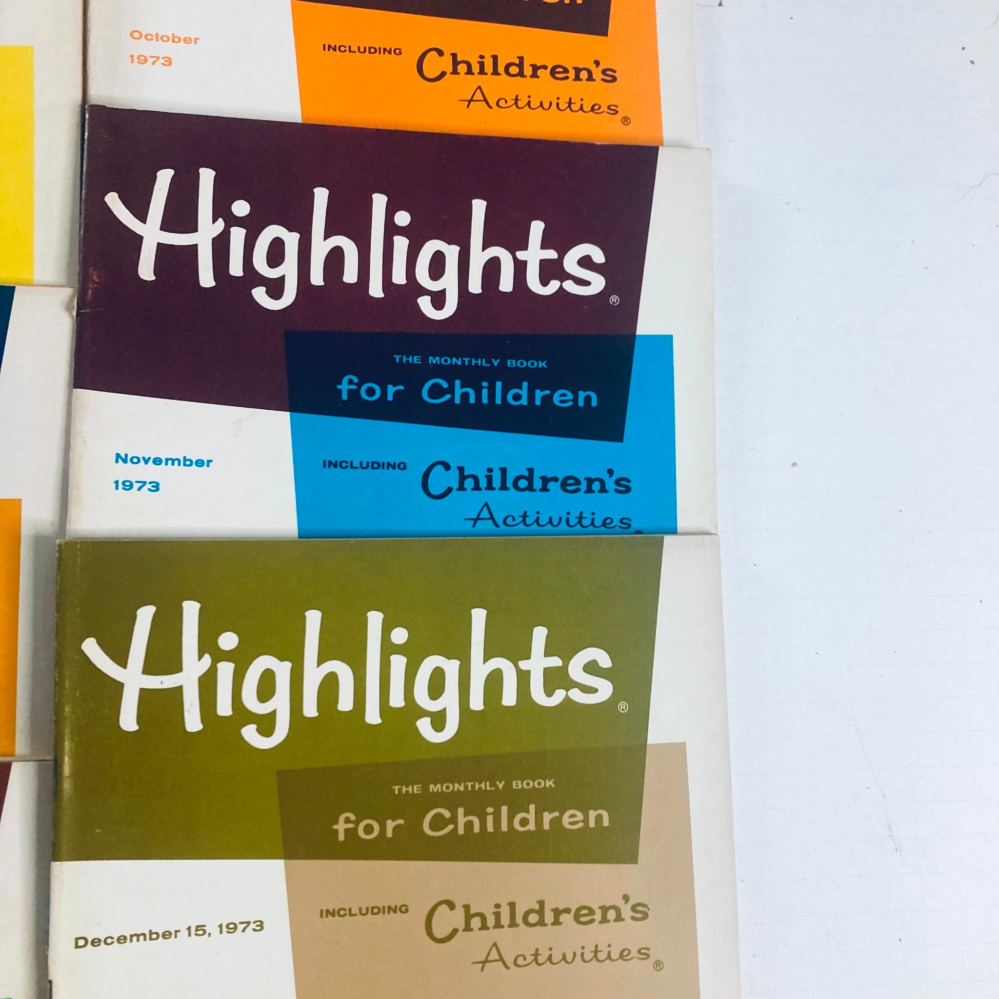 Lot of 10 1973 Highlights for Children Magazine including a close-up of October, November, and December covers in retro style.