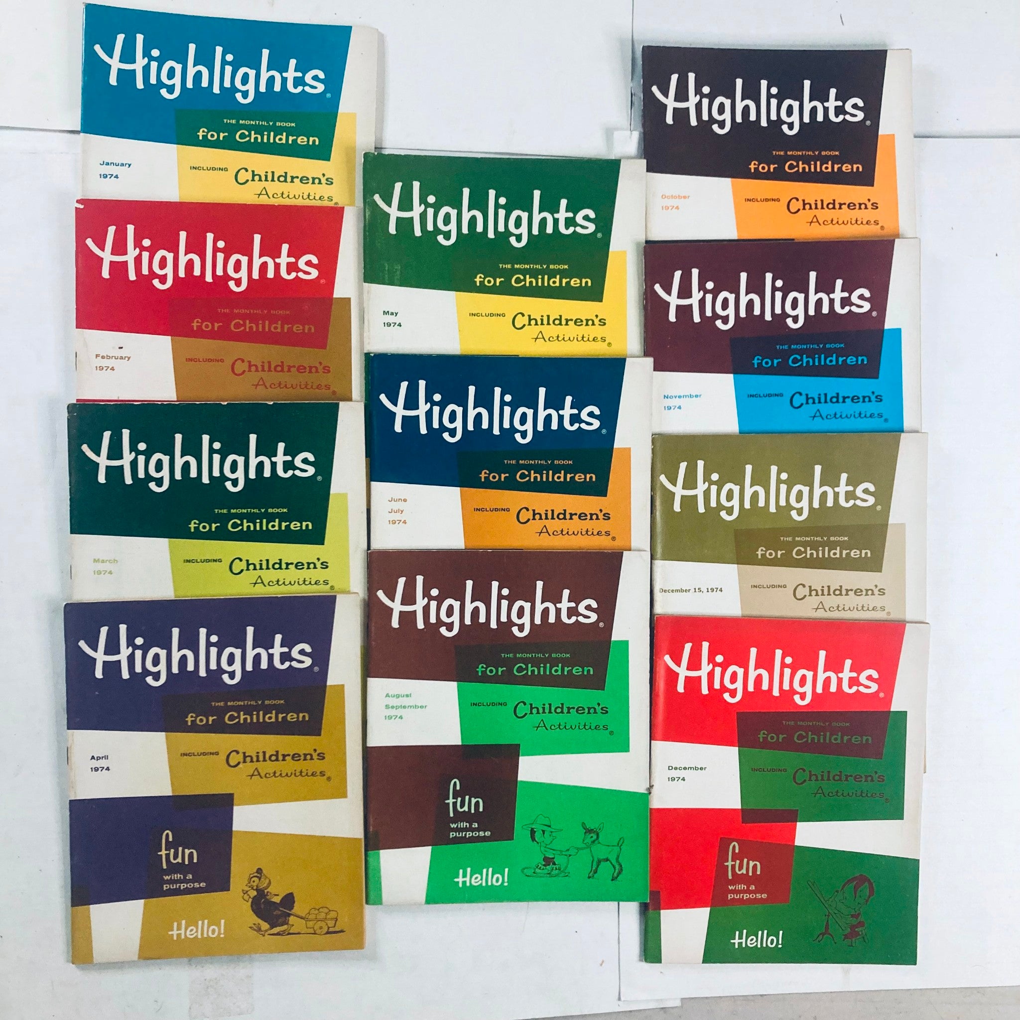 Lot of 11 1974 Highlights for Children Magazine covers showcasing various monthly issues from January to December, featuring colorful designs and children's activities.