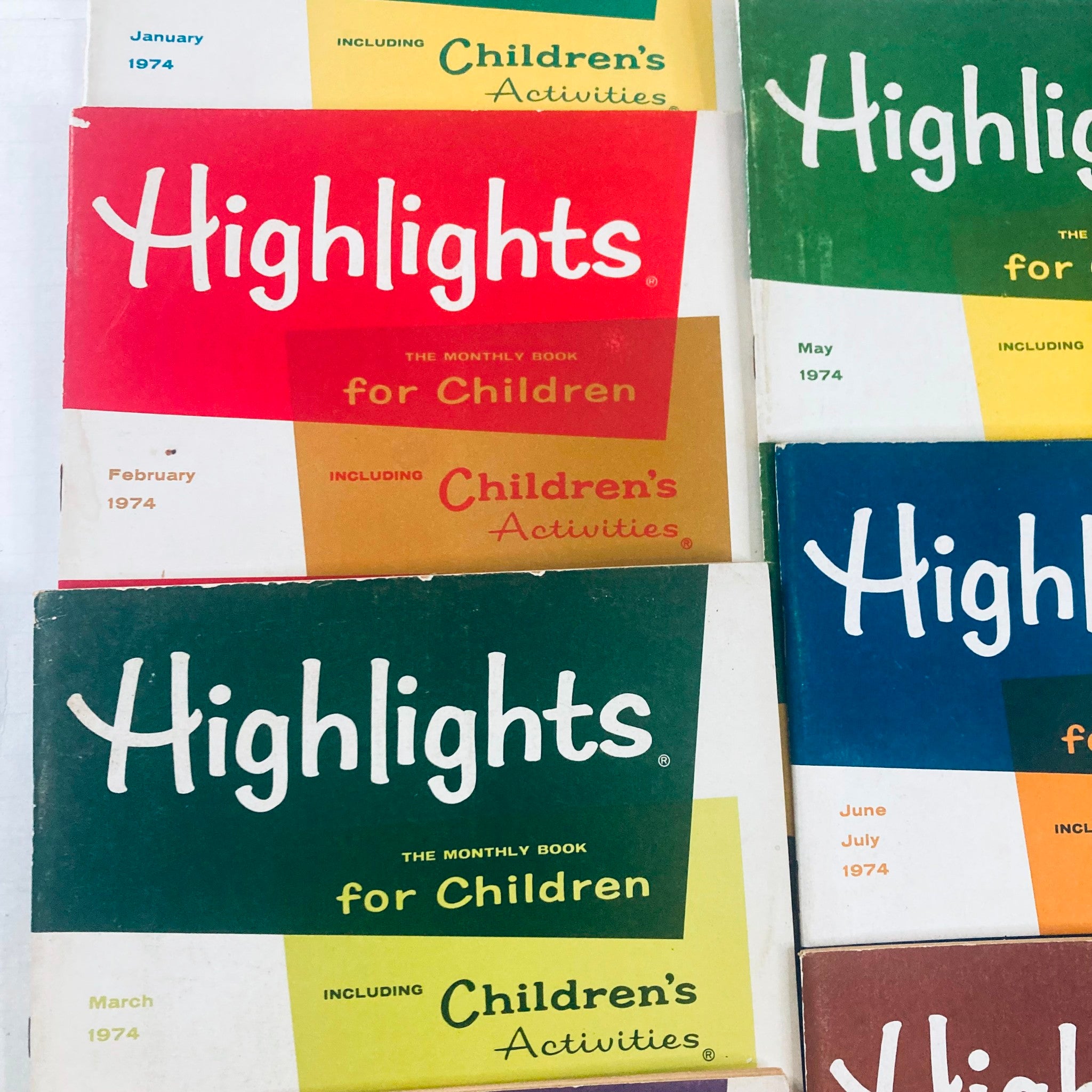 Close-up view of multiple 1974 Highlights for Children Magazine covers, highlighting January through May issues, decorated with vibrant colors and engaging children's activities.