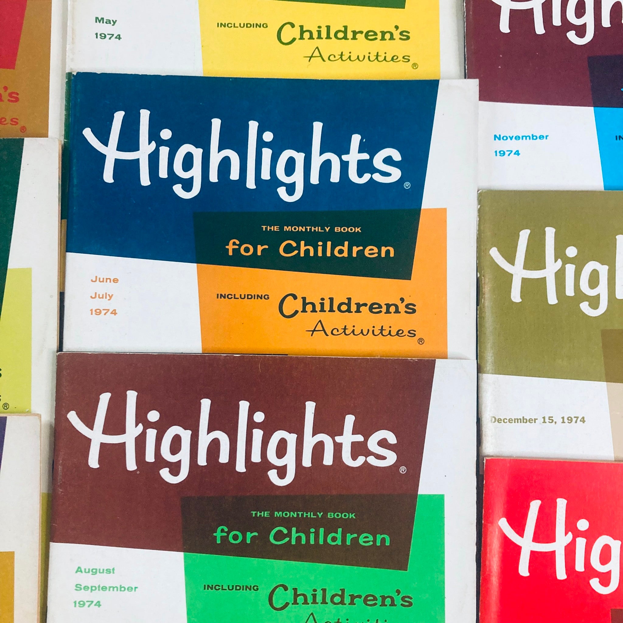 Lot of 11 1974 Highlights for Children Magazine featuring colorful covers from January to May and highlighting children's activities.