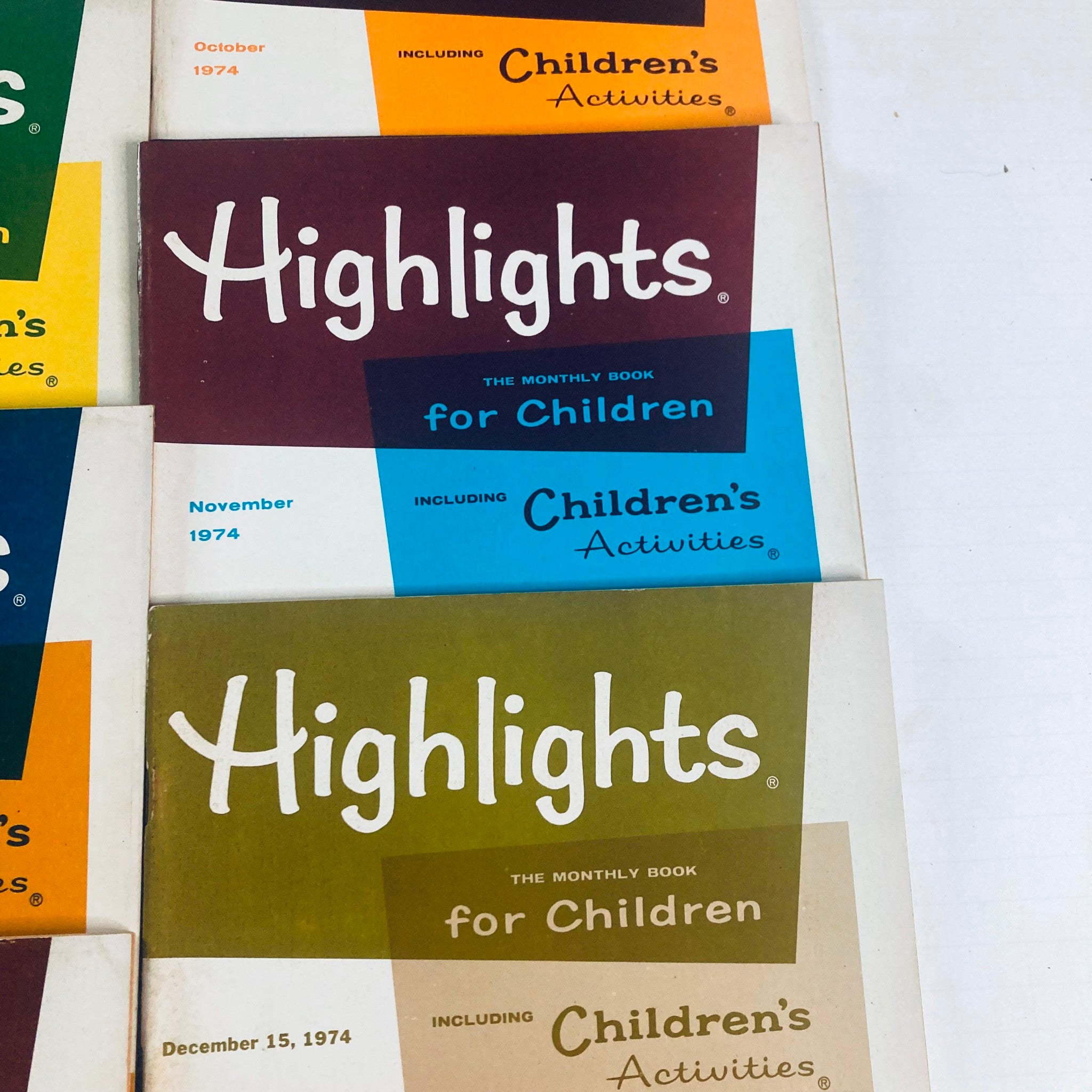 Lot of 11 1974 Highlights for Children Magazine showcasing monthly editions from October to December, emphasizing fun and educational content.