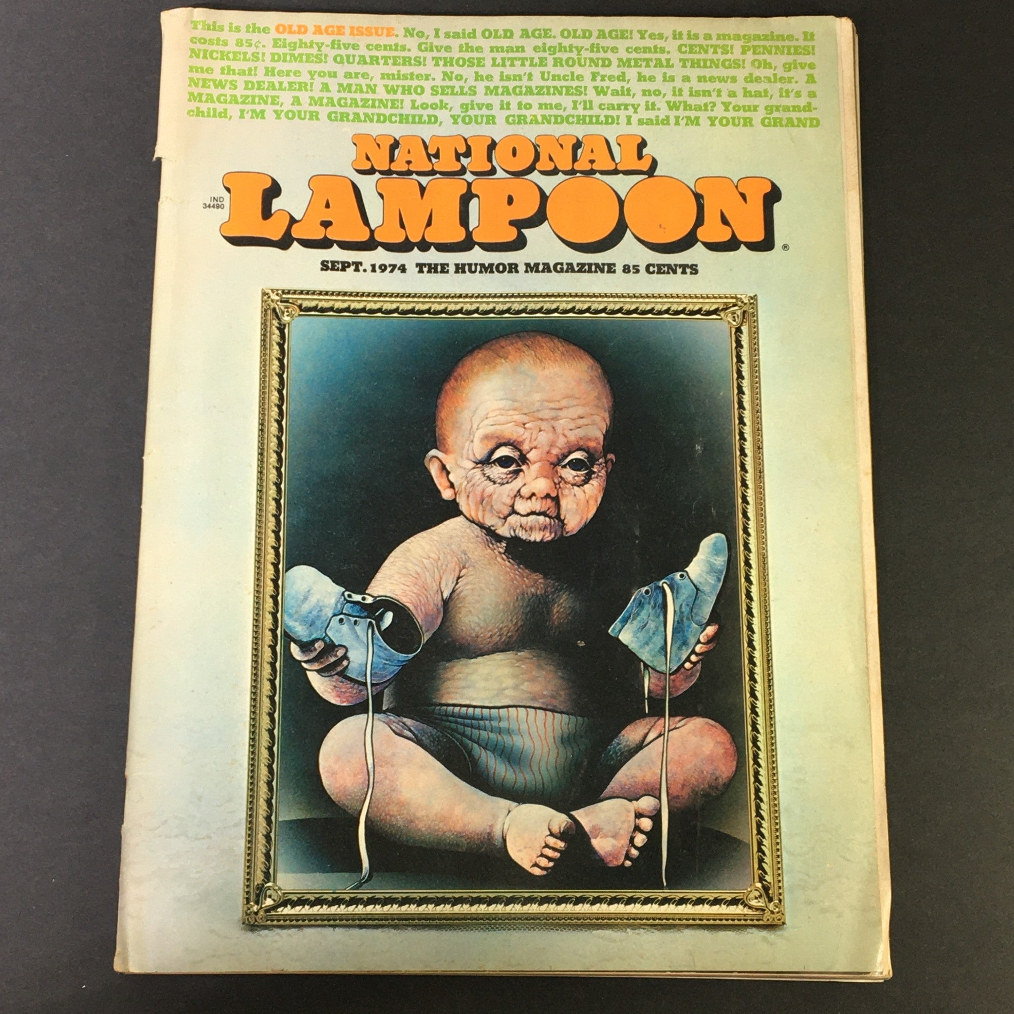 Cover of National Lampoon Magazine September 1974 Old Age Issue featuring an artistic depiction of a baby with aged features, holding blue shoes, and showcasing the iconic title and humor of the publication.