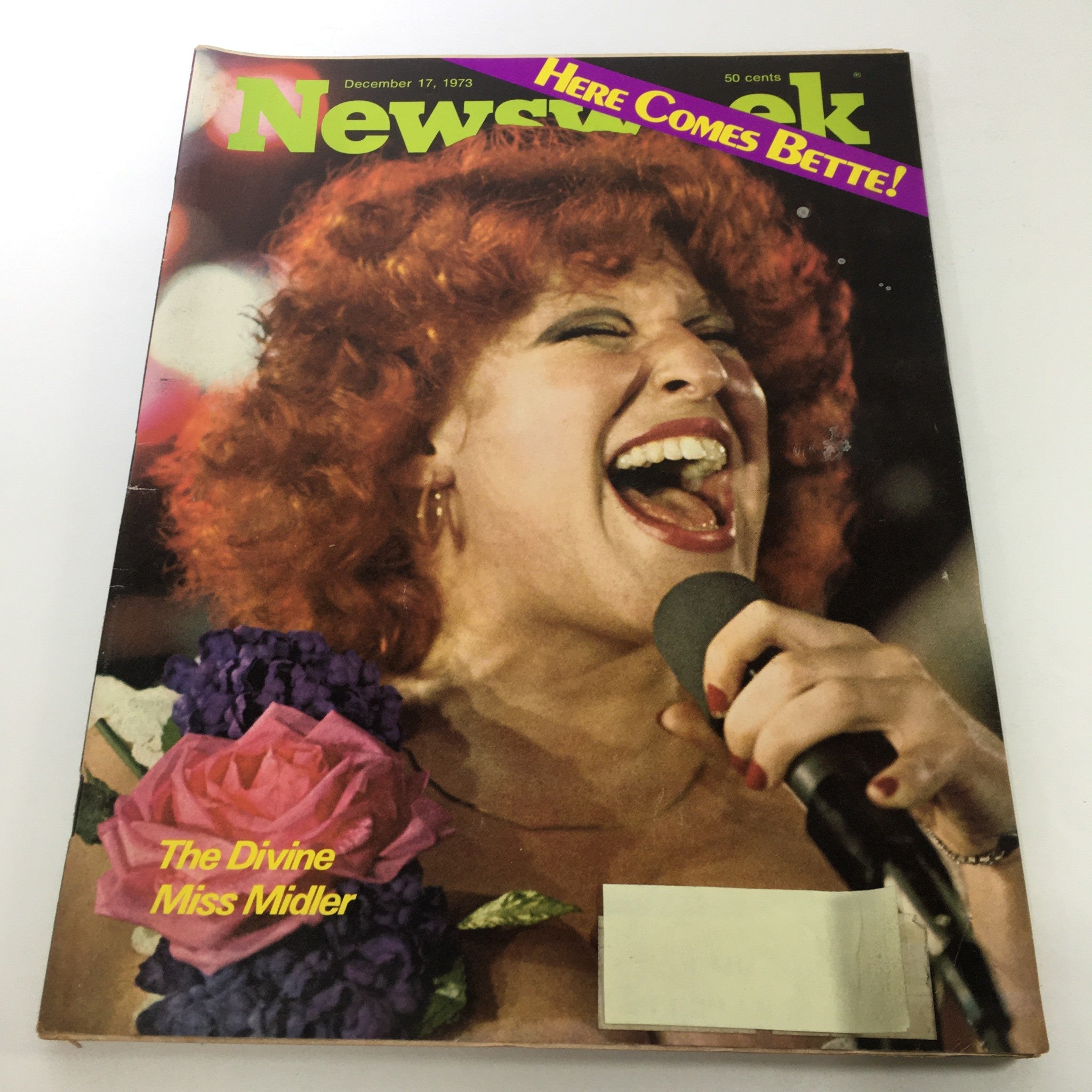 Cover of Newsweek Magazine dated December 17, 1973, featuring Bette Midler singing passionately with red hair and a microphone, surrounded by flowers, titled 'Here Comes Bette & The Divine Miss Midler'.