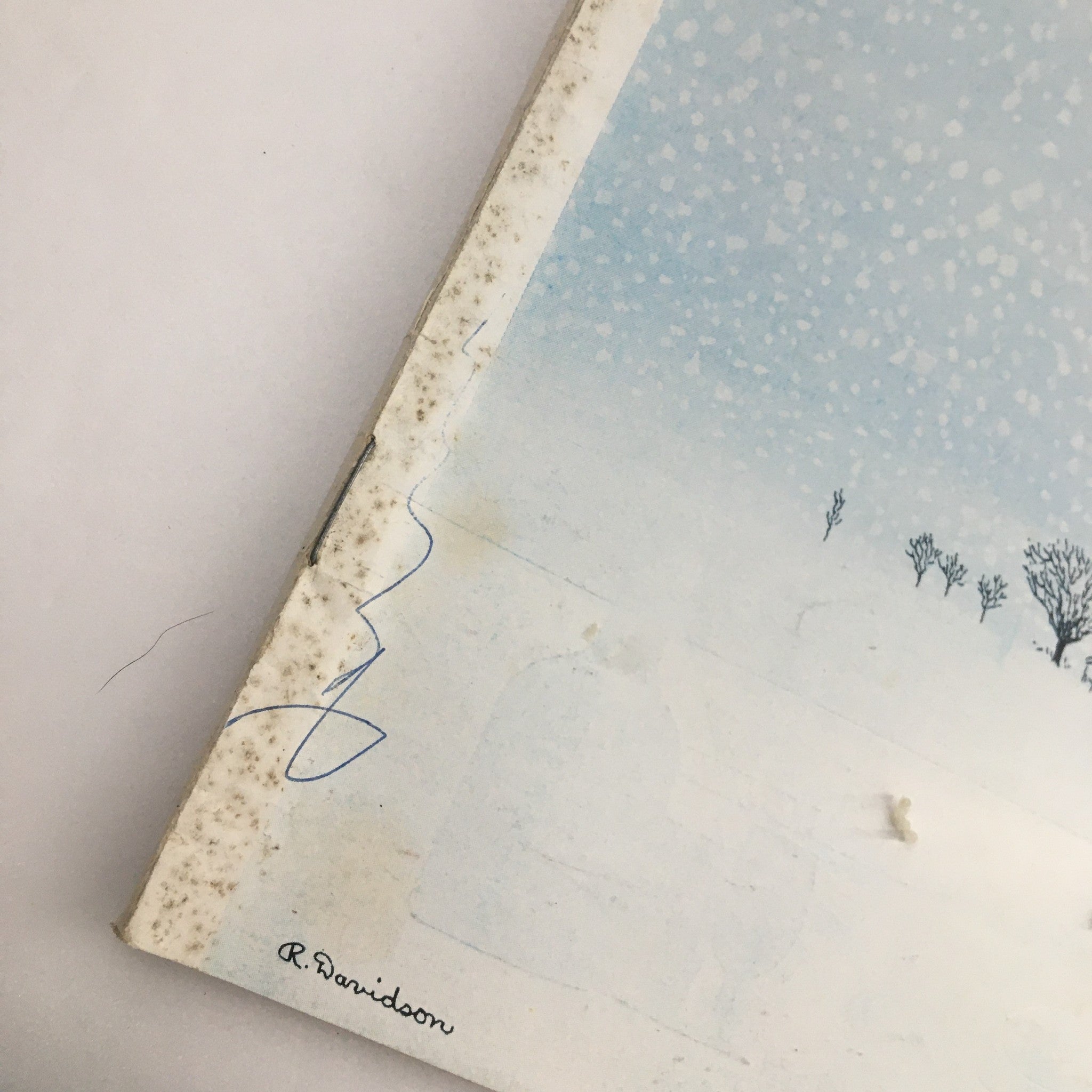 Close-up image of the cover edge of The New Yorker Magazine February 3, 1973, displaying the signature of Raymond Davidson, the illustrator of 'Winter House', amidst a snowy background.