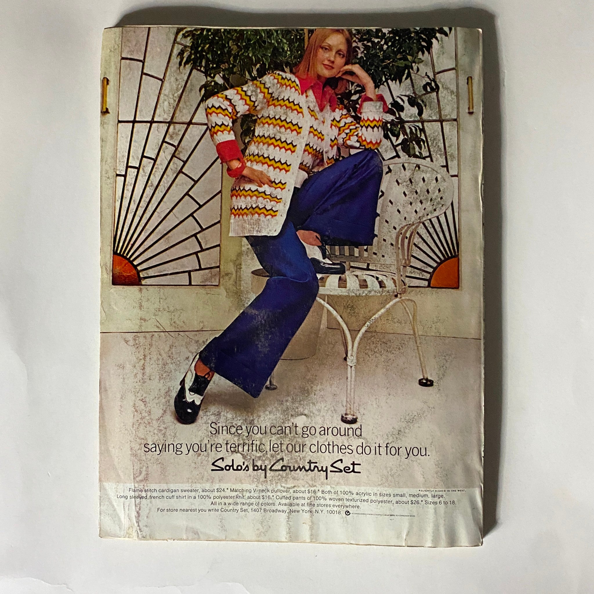 Back cover of Glamour Magazine December 1973 displaying a vintage fashion advertisement for Country Set, illustrating 1970s clothing styles with a model posing in a chic outfit.