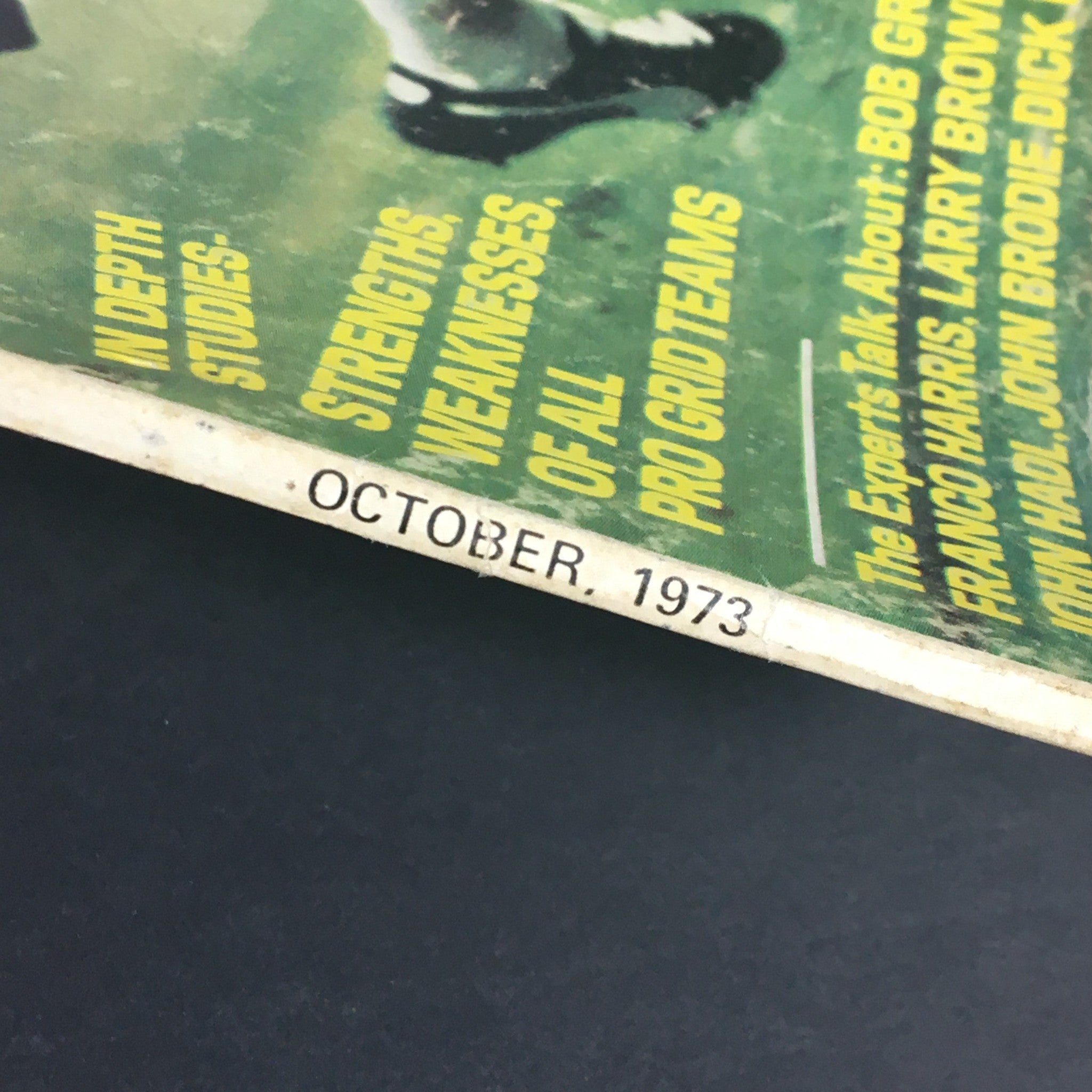 Close-up of the spine of the VTG Super Sports Magazine October 1973, displaying the issue date and detailed descriptions of featured football experts and studies.