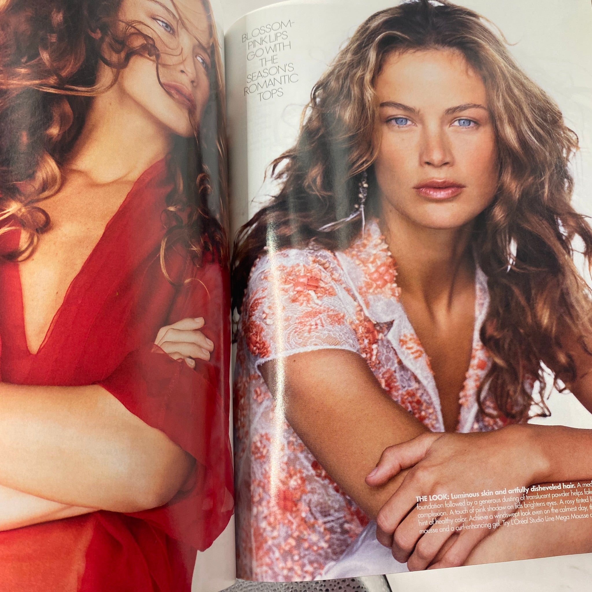 A vibrant fashion editorial image from Elle Magazine February 2002 showcasing Carolyn Murphy, emphasizing beauty and style trends of the early 2000s.