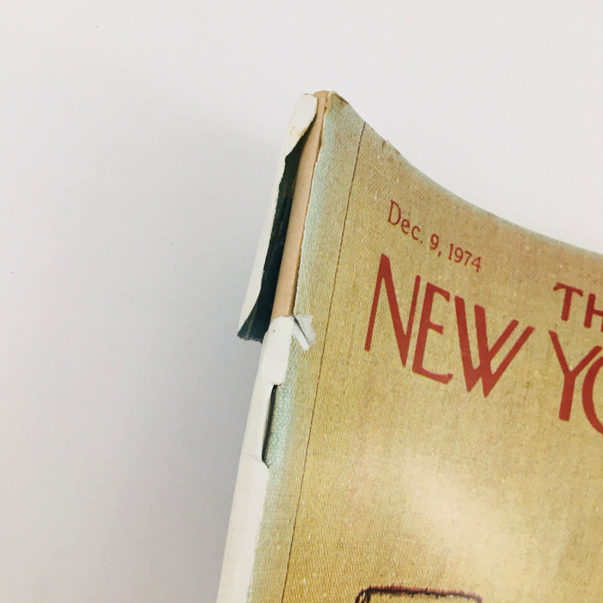Side view of The New Yorker Magazine December 9 1974 highlighting the spine with visible wear, emphasizing its vintage condition and no label.