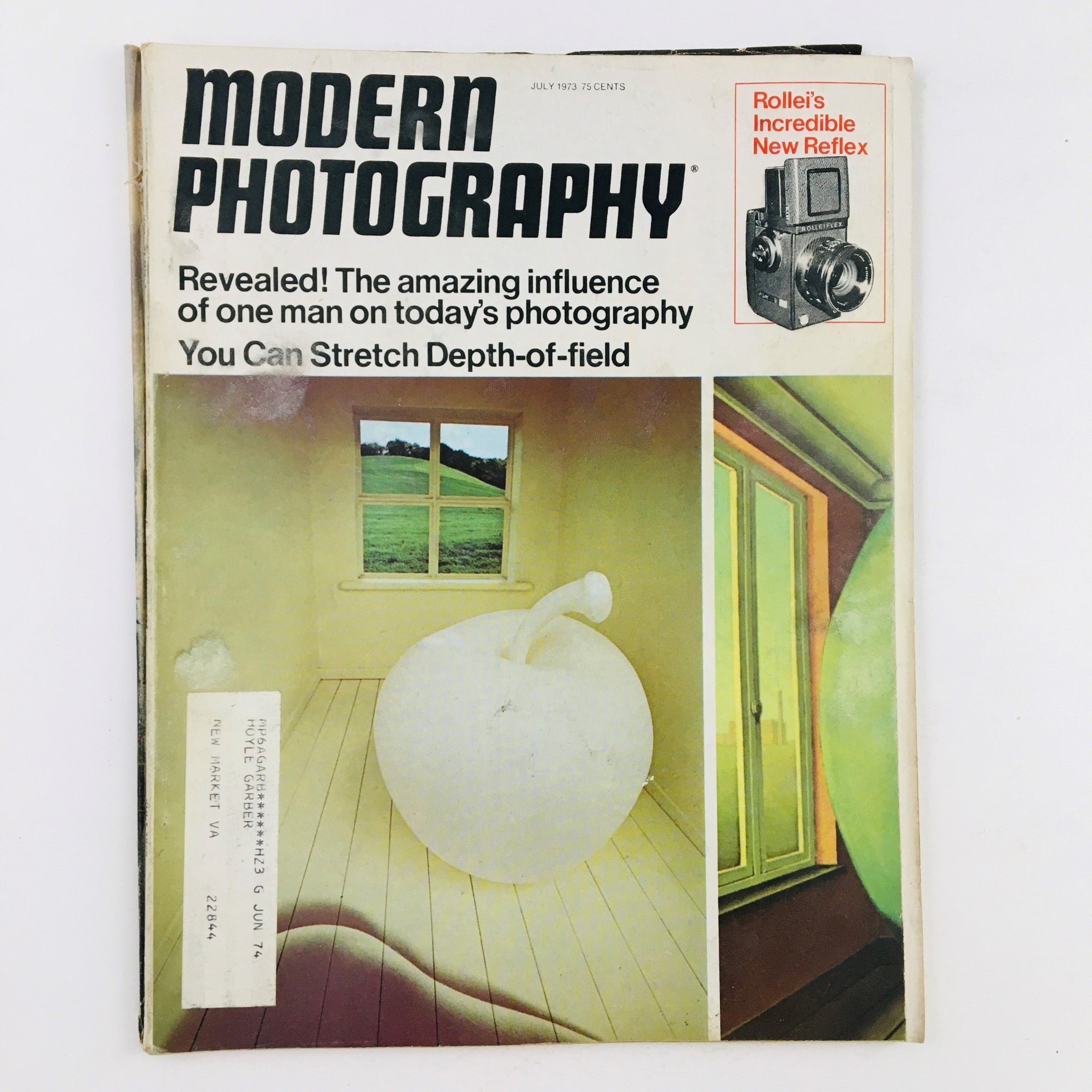 Cover of Modern Photography Magazine July 1973 featuring the headline about the influence of one man on today's photography, with a design showcasing an abstract apple and a window view.