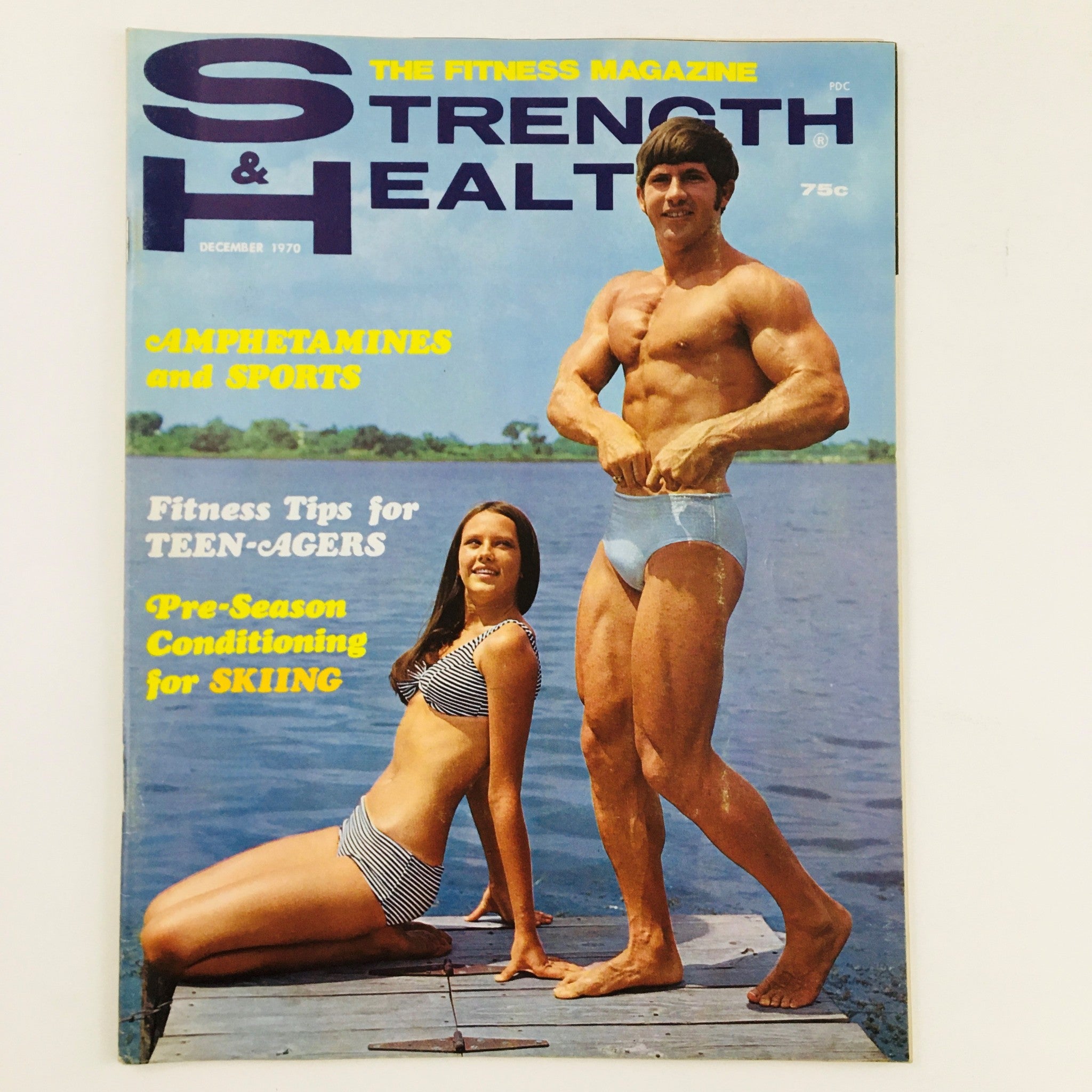 Cover of Strength & Health Magazine December 1970 featuring a muscular man in swimwear and a woman in a striped bikini, showcasing fitness tips and sports insights.