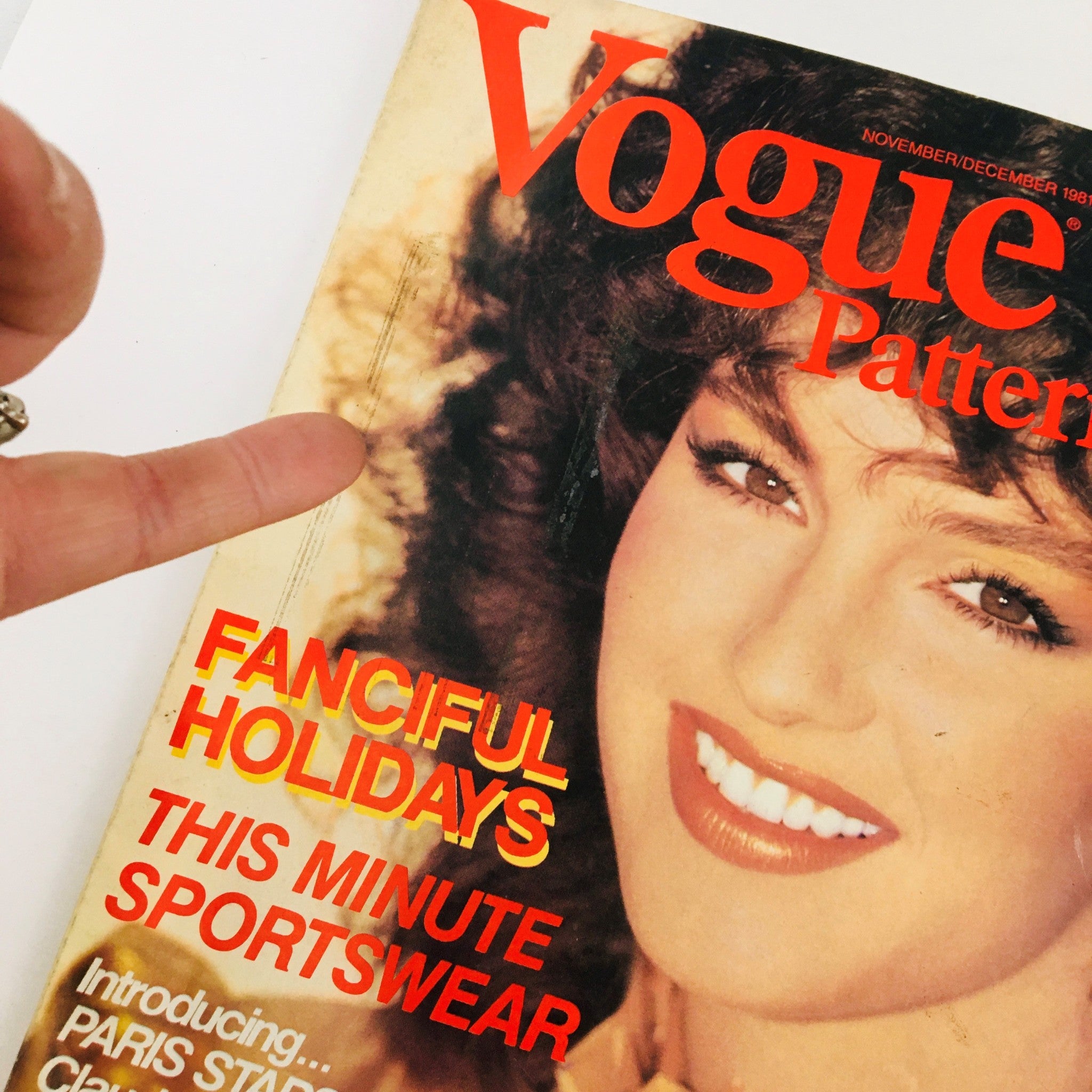 Close-up view of Vogue Patterns Magazine November 1981 Cover emphasizing the title and model's features, introducing Paris Stars Claude Montana and Guy Laroche.