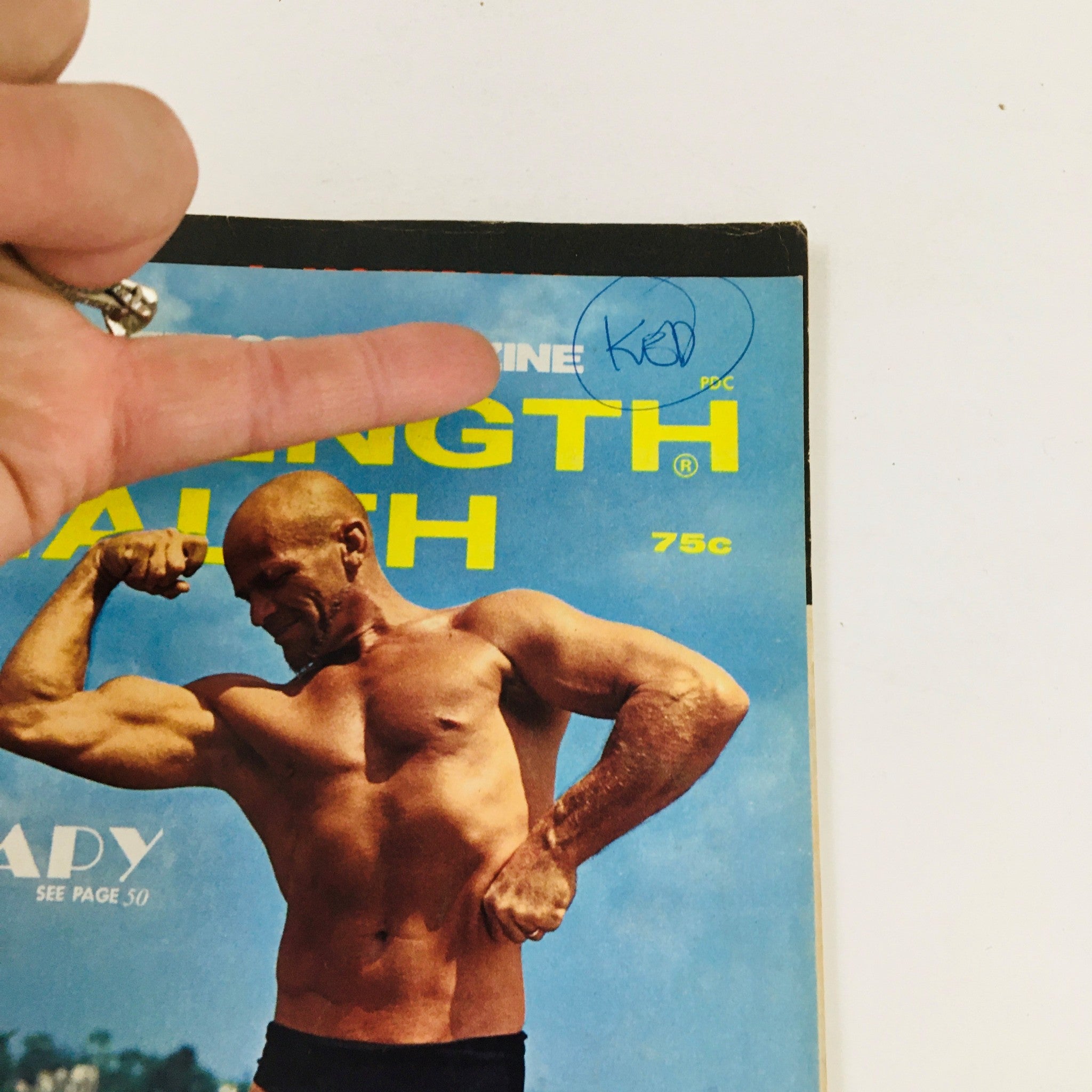 Close-up of the Strength & Health Magazine September 1970 cover, showing a bodybuilder flexing and a handwritten note.