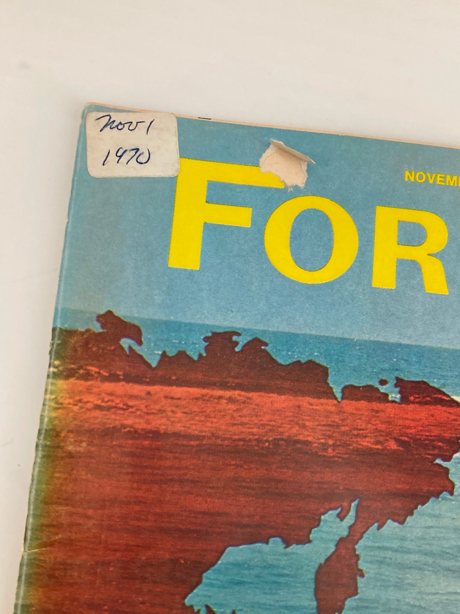 Close-up detail of the cover of Forbes Magazine, November 1, 1970, highlighting the title 'Forbes' and a sticker indicating the date, with a colorful map of the Pacific region.