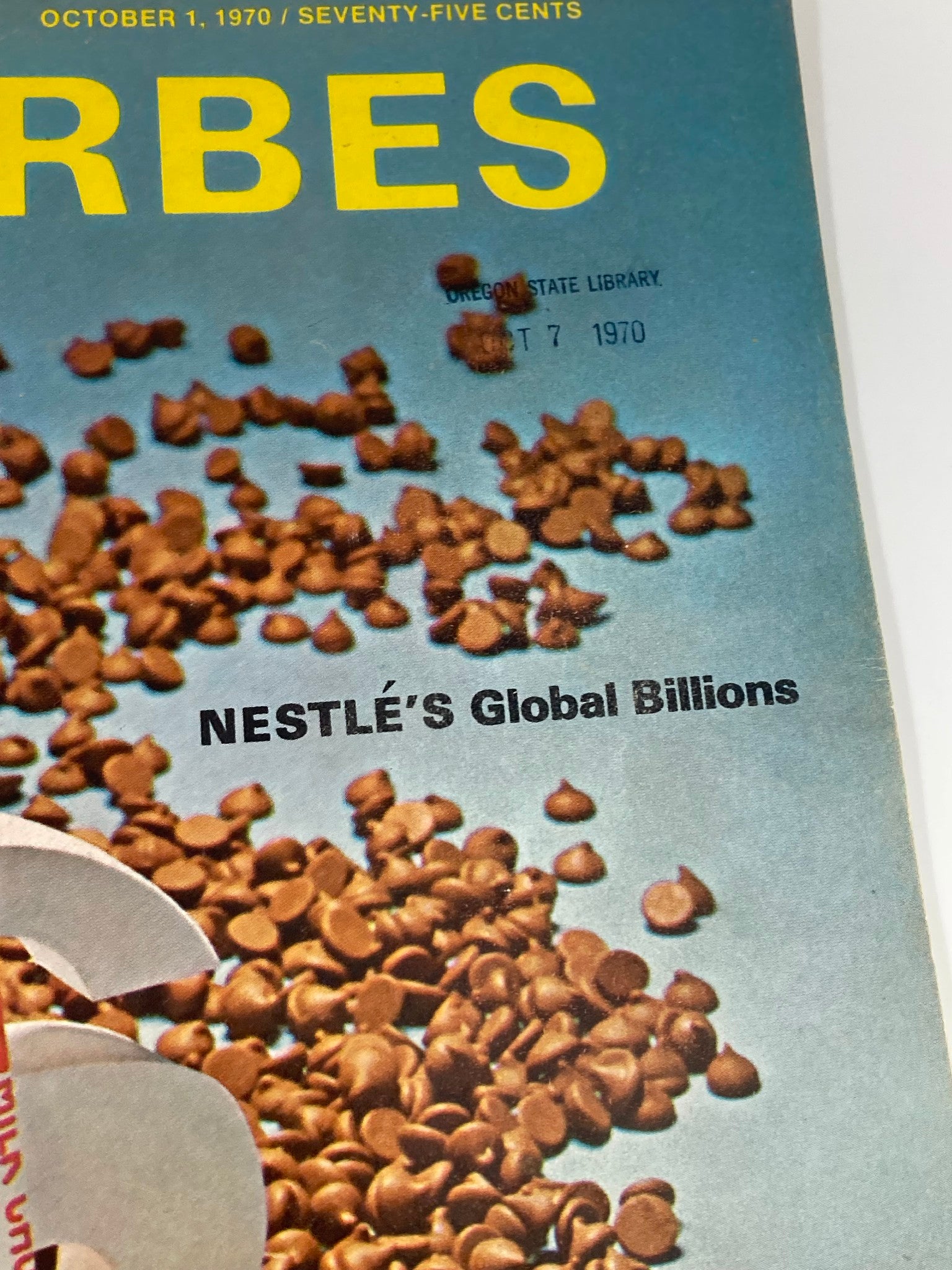 Cover of the VTG Forbes Magazine October 1, 1970, featuring an article on Nestlé's Global Billions of Chocolates with a distinct blue background and chocolate drops scattered over it.