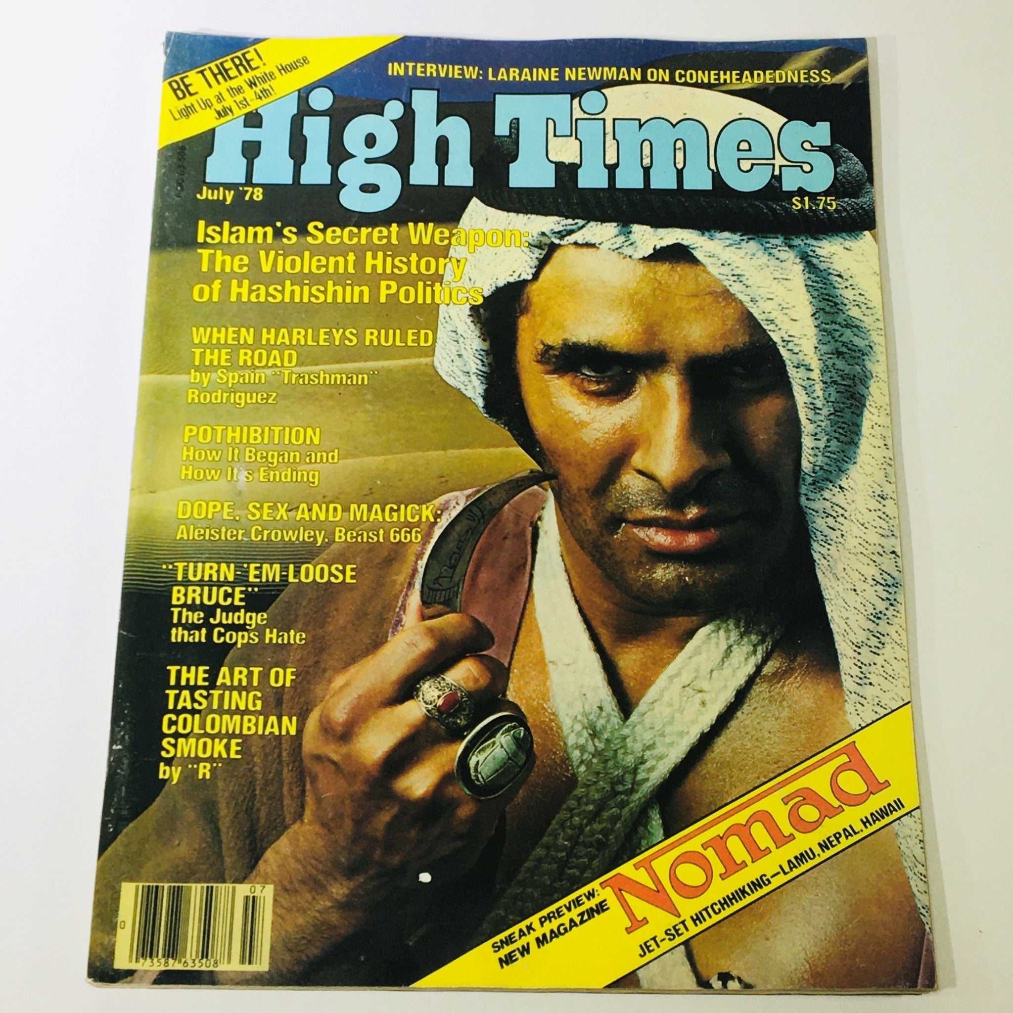 VTG High Times Magazine July 1978 cover showcasing an article about Hashishin politics and an interview with Laraine Newman, featuring a strong male figure in traditional attire holding rings, embodying 1970s cannabis culture.