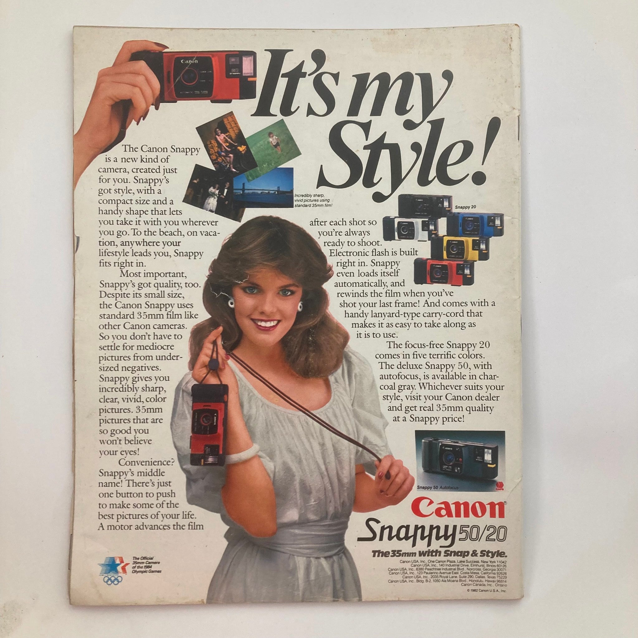 Back cover of Life Magazine February 1983 Vol 6 No. 2 featuring an advertisement for the Canon Snappy 50/20 camera. The ad illustrates the camera's features with a model showcasing the stylish design, appealing to photography enthusiasts of the time.