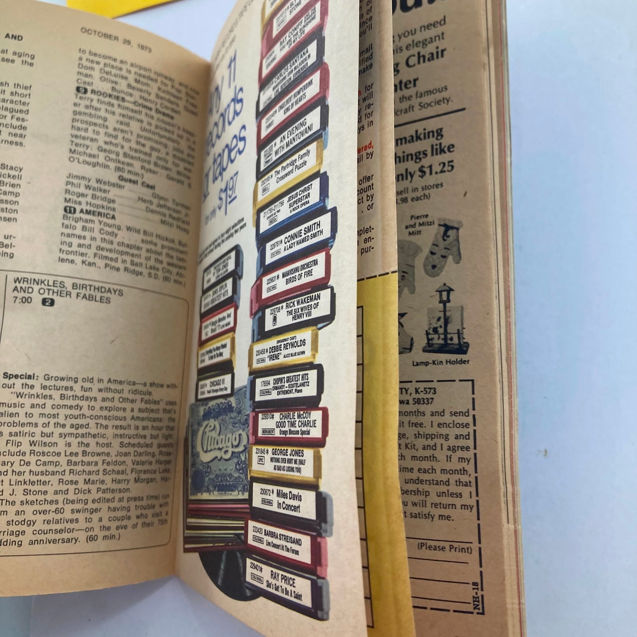 Inside pages of TV Guide Magazine from October 27, 1973, showing program listings and advertisements, providing a glimpse into television history during that era.