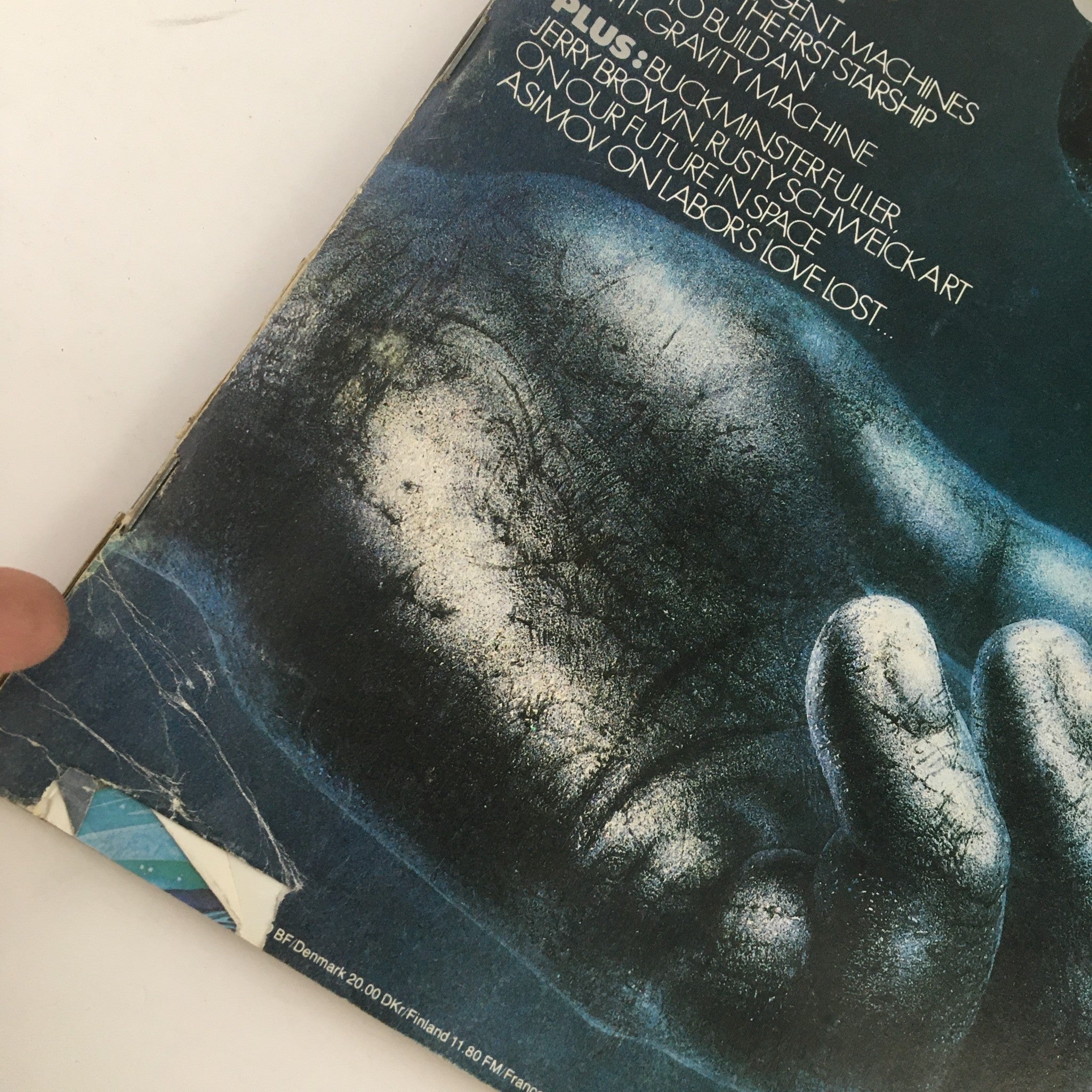 Close-up view of the damaged corner of the Omni Magazine January 1979 cover, highlighting wear and tear while still displaying the prominent title and imagery related to atomic science.