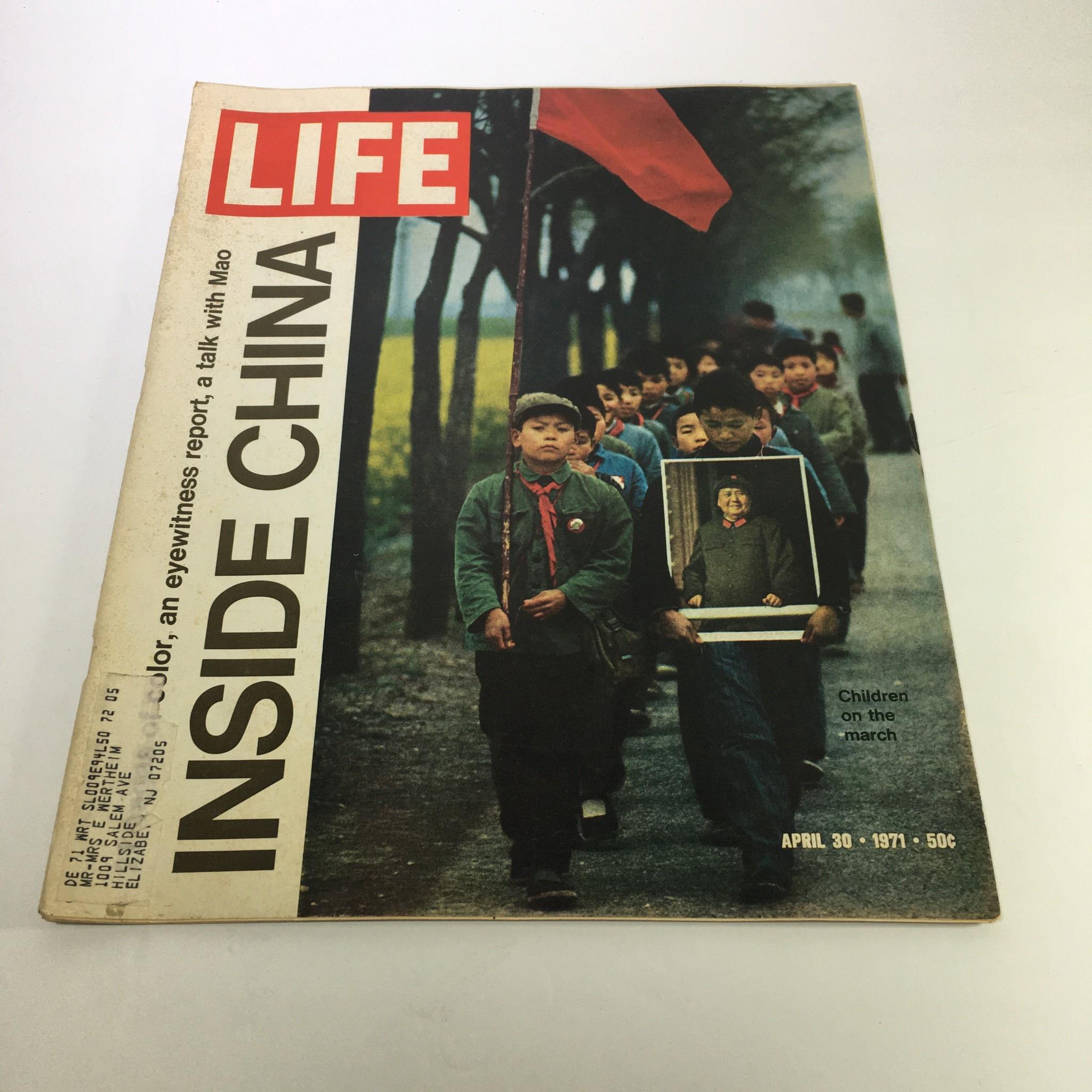 Cover of Life Magazine, April 30, 1971 edition, featuring the title 'Inside China: Children on the march'. The image shows a line of children marching, with one child in the foreground holding a framed picture. This historic magazine explores significant cultural themes in China during a transformative era.