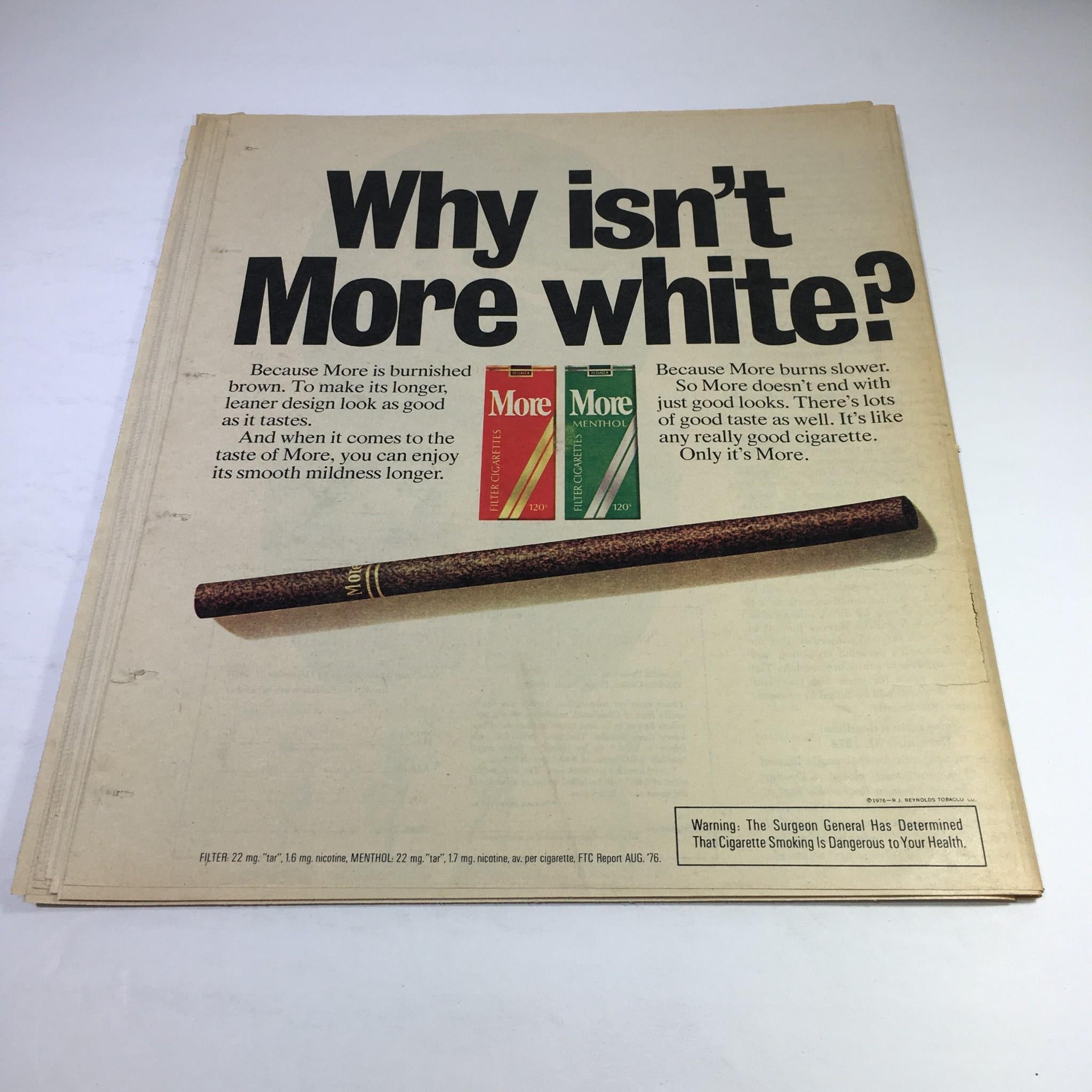Vintage advertisement from New York News Magazine, December 5, 1976, featuring a humorous question 'Why isn't More white?' regarding More cigarettes, illustrating the brand's product packaging and highlighting its features. Title: New York News Magazine Dec 5 1976 Bing On Broadway A Child's Guide To WW II.