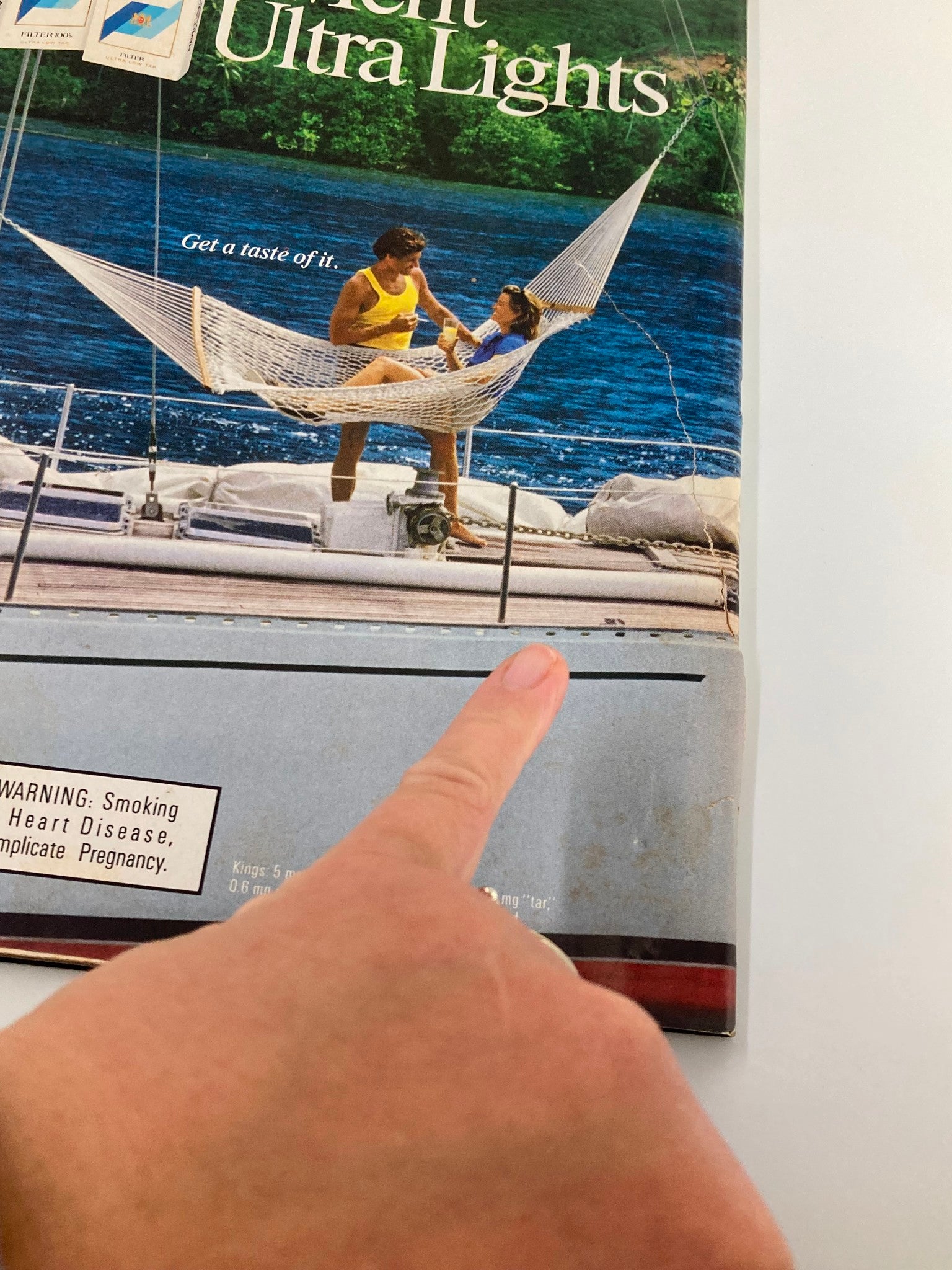 Back cover of the People Weekly Magazine from October 6, 1986, showing a romantic scene with a couple on a hammock by the water, promoting a nostalgic lifestyle relevant to the era.